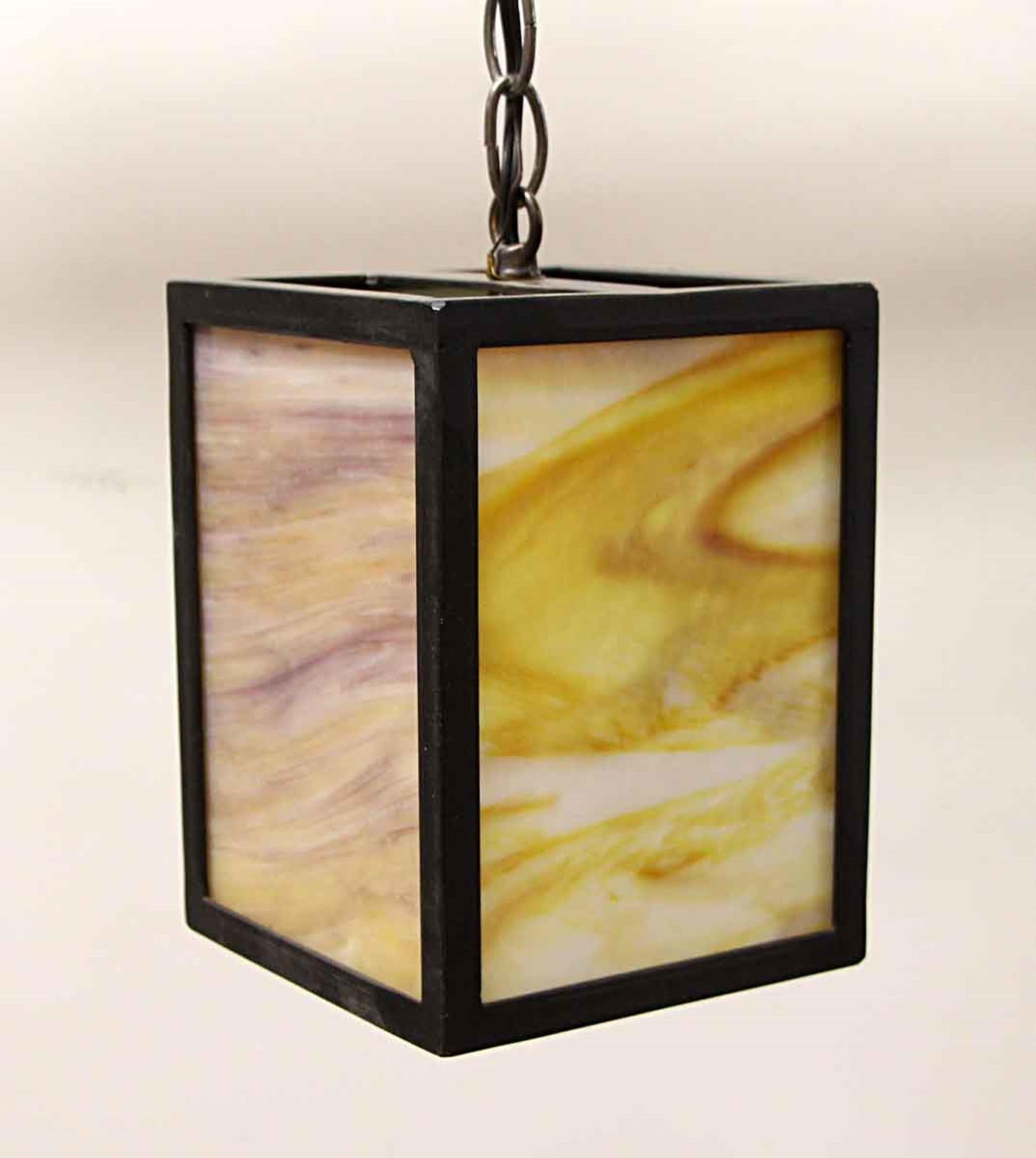 Prairie School style or Mid-Century Modern style iron framed pendant lantern from the 2010s with tan and amber slag stained glass and brass hardware. Cleaned and rewired. Please note, this item is located in our Los Angeles location.