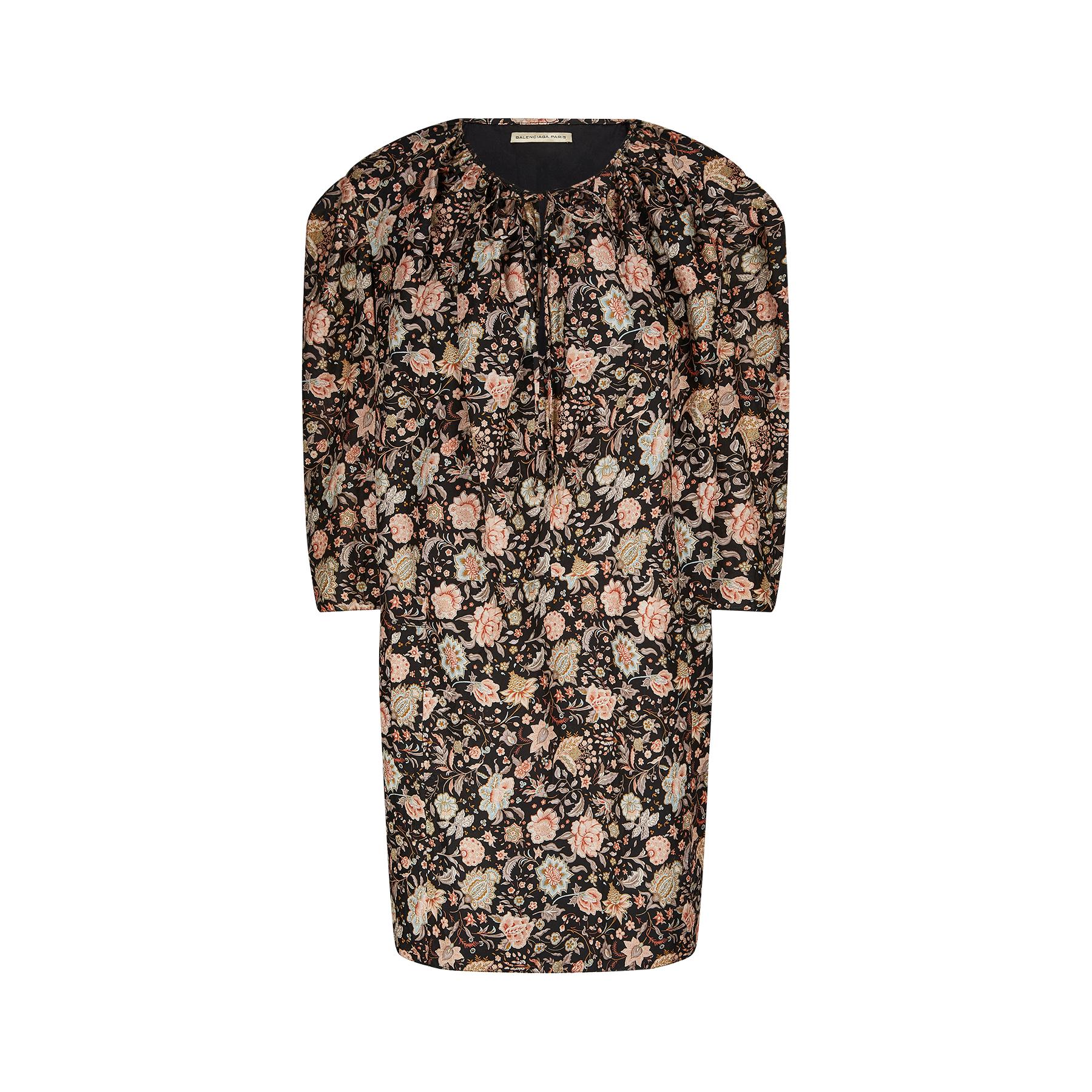 Nicolas Ghesquiere for Balenciaga floral cotton dress with date label 2010.  The dress is a tunic style in an antique look print featuring a floral and leaf arrangement in muted orange and beige tones against a smoky black background. This has