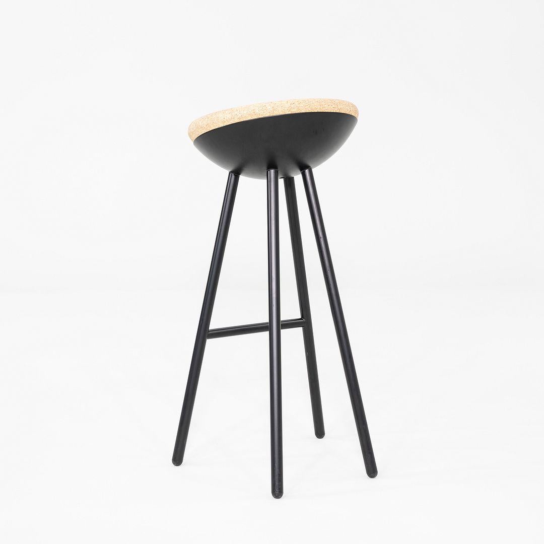 This is a Boet Bar Stool, originally designed by Note Design Studio in 2011. These particular examples were produced by Mitab in Sweden in the 2010s. The stools are comprised of a black metal base with a cork seat. 
 
 The listed price includes one