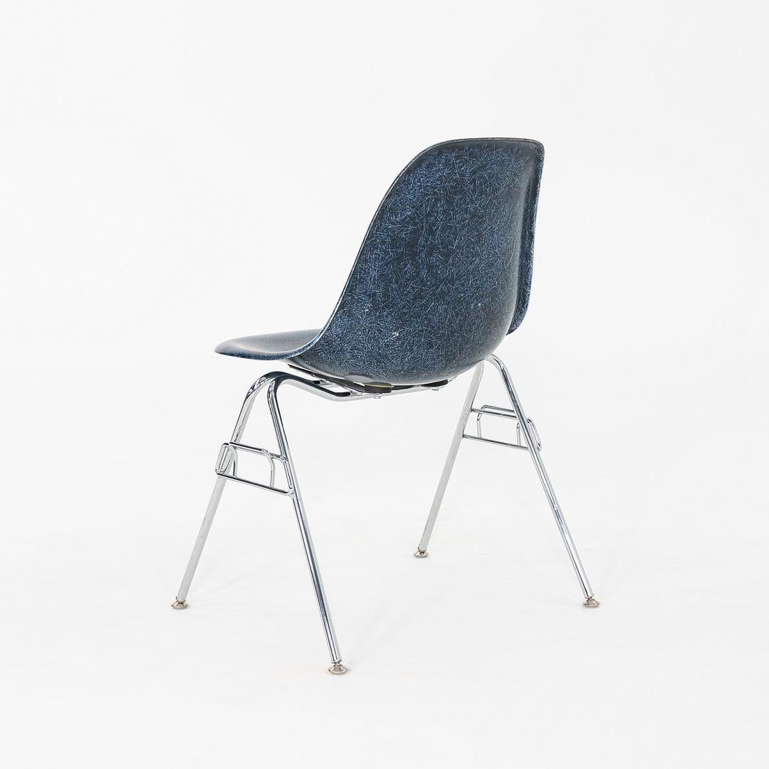This is a pair of DSS Chairs, originally designed by Ray and Charles Eames in 1955. These chairs were produced by Modernica in Los Angeles, California in the 2010s. These chairs feature molded fiberglass shells in blue, and have stackable bases made