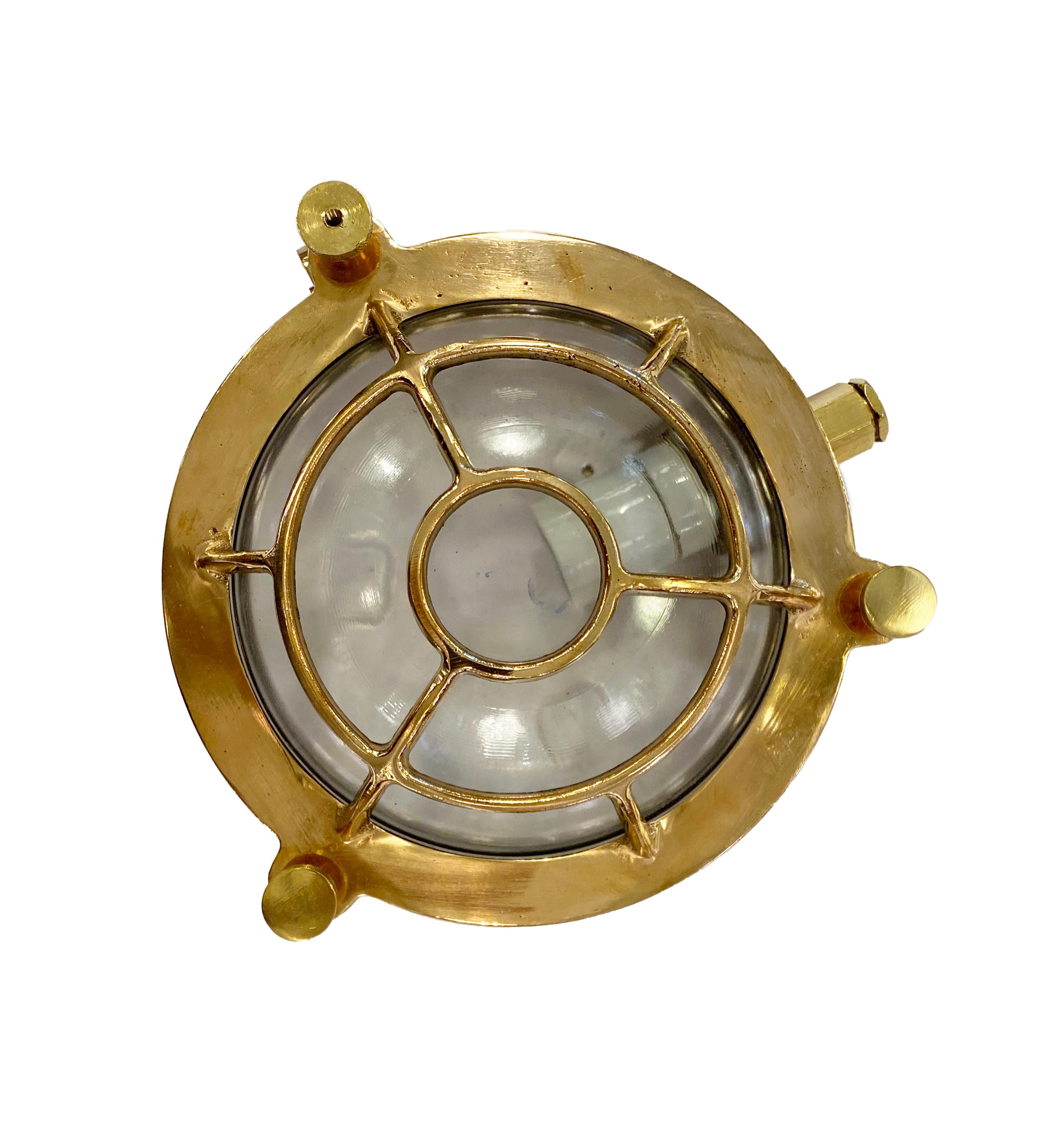 Cast brass round nautical bulkhead ship light. Newly wired and takes one E26 household medium base light bulb. Can be used either as a ceiling light or wall sconce. With new industrial rubber gasket. Cleaned and rewired. Small quantity available at