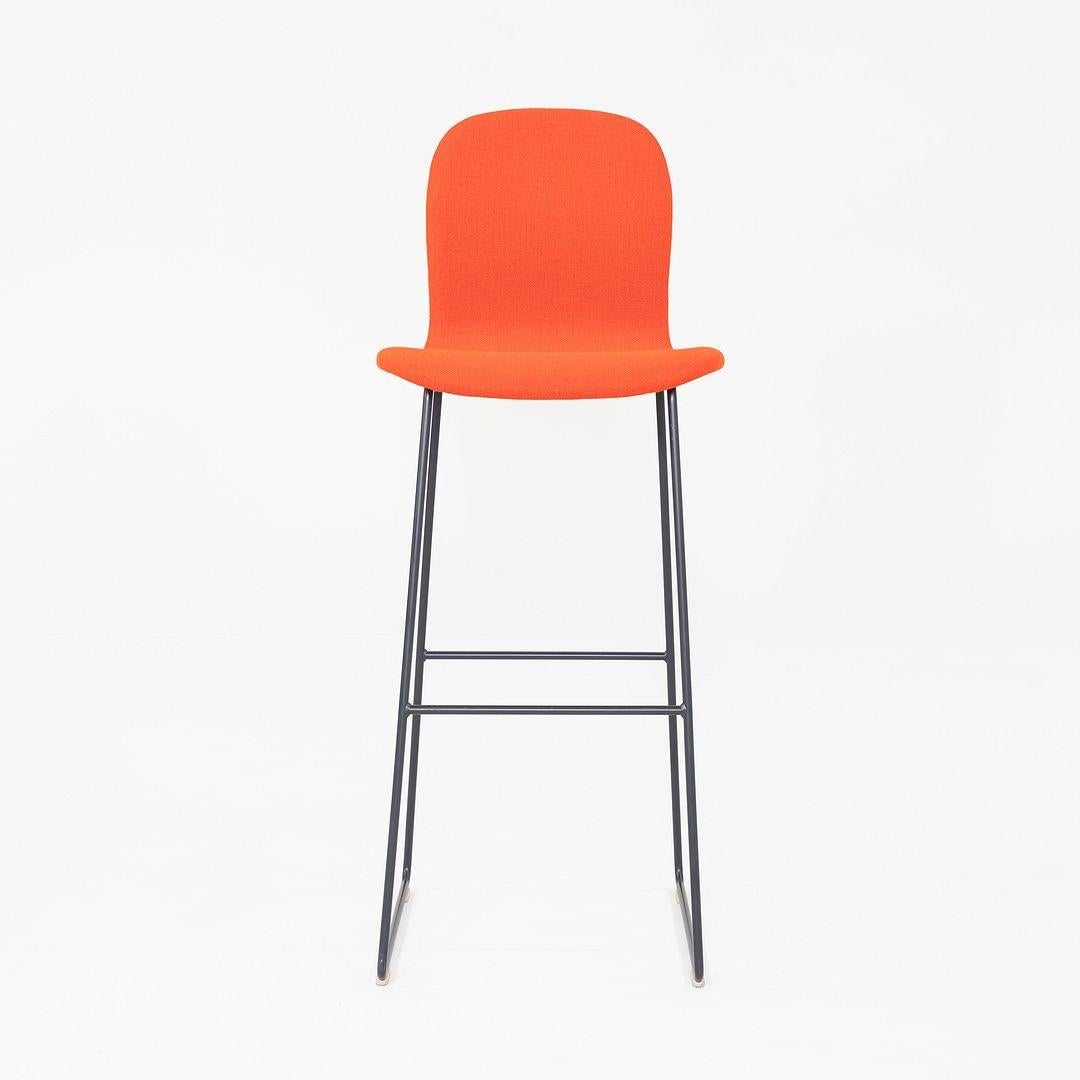 This is a set of four Tate Bar Stools, originally designed by Jasper Morrison for Cappellini in 2000. These particular stools were produced in Italy in the 2010s. The stools feature a stainless-steel sled base, and have a bent beech plywood seat and