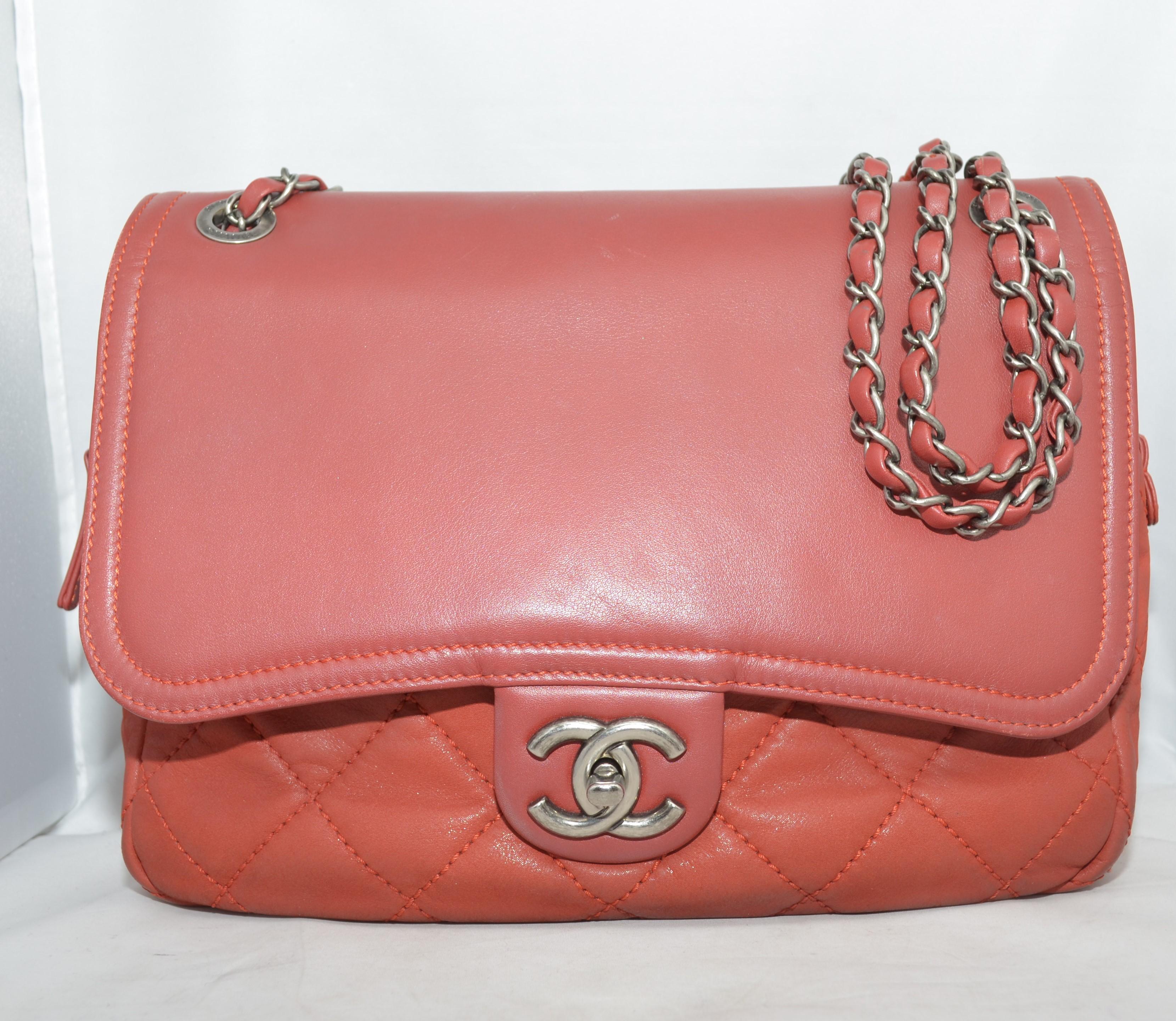 Chanel shoulder bag is featured in a brick red color in a quilted soft crumpled leather base and a nappa leather flap. Bag has gunmetal hardware throughout with a signature CC turnlock closure and zippered top. Interior has a full jacquard lining