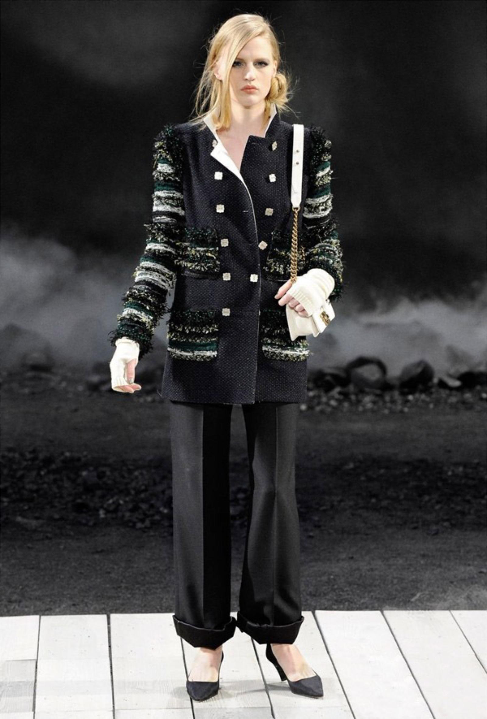 An incredibly chic and highly coveted Chanel black and green beaded fringe sleeve double breasted jacket dating back to Karl Lagerfeld's epic 2011 fall-winter runway collection. This ultra rare jacket was look number 23; modeled by the beautiful