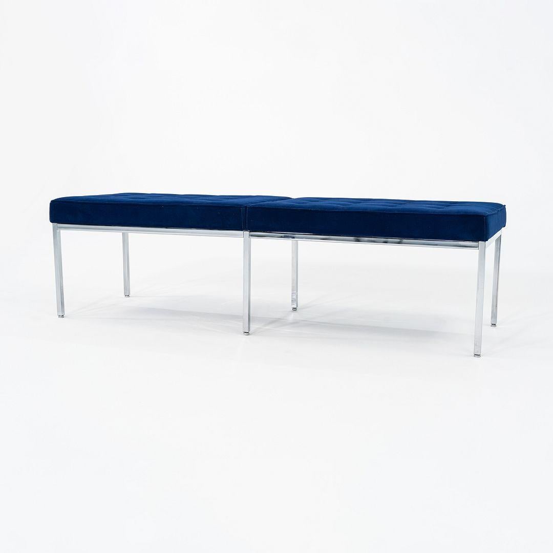 This is a Florence Knoll Bench, designed for Knoll in 1954. This particular example dates to 2011. The design incorporates a simple chromed steel frame with a padded seat that is upholstered in a blue fabric. It has a geometric profile, a la