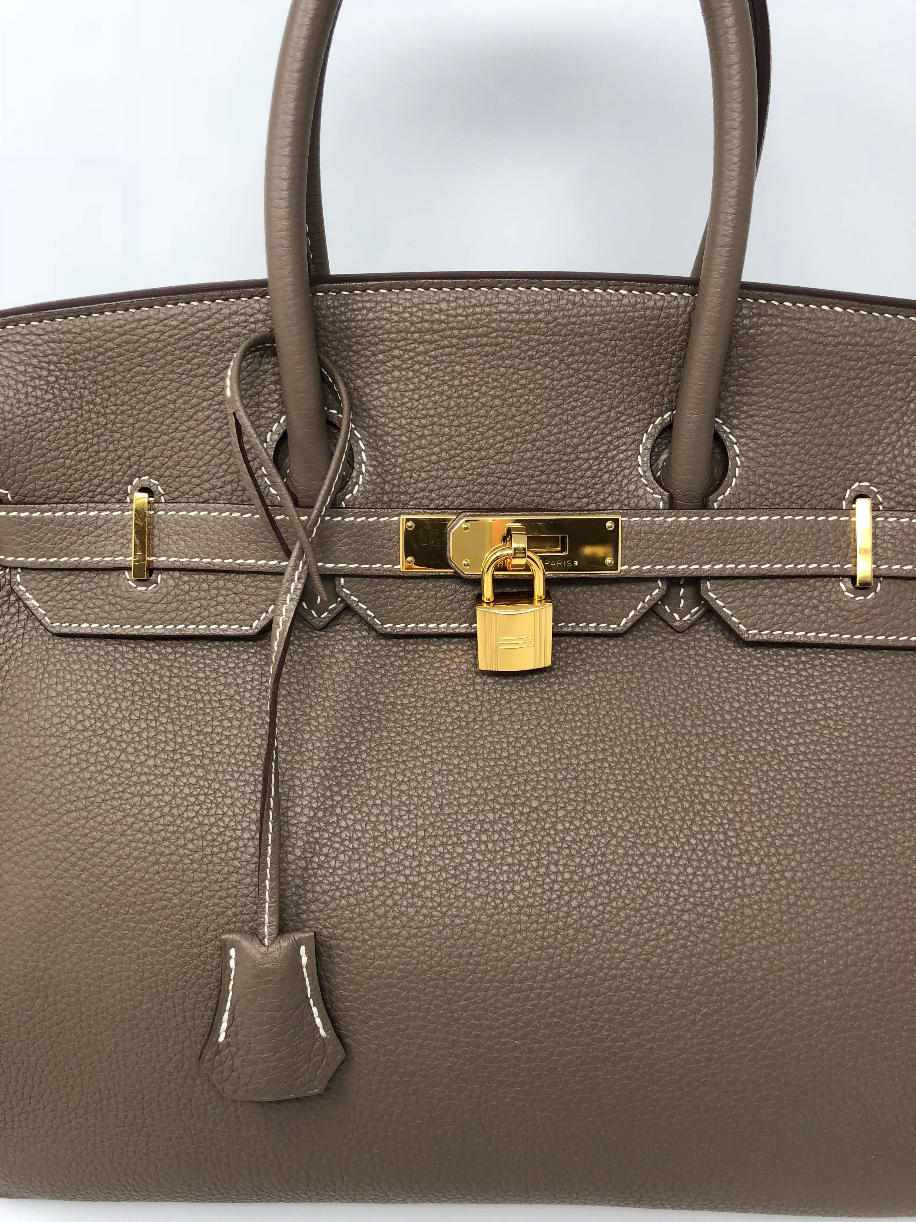 This guaranteed authentic Hermes Birkin 35 is in Etoupe color and in Togo leather.  Most wanted color Etoupe goes with everything. The smooth Togo leather is durable and scratch resistant. The gold hardware looks great and comes with the clochette,
