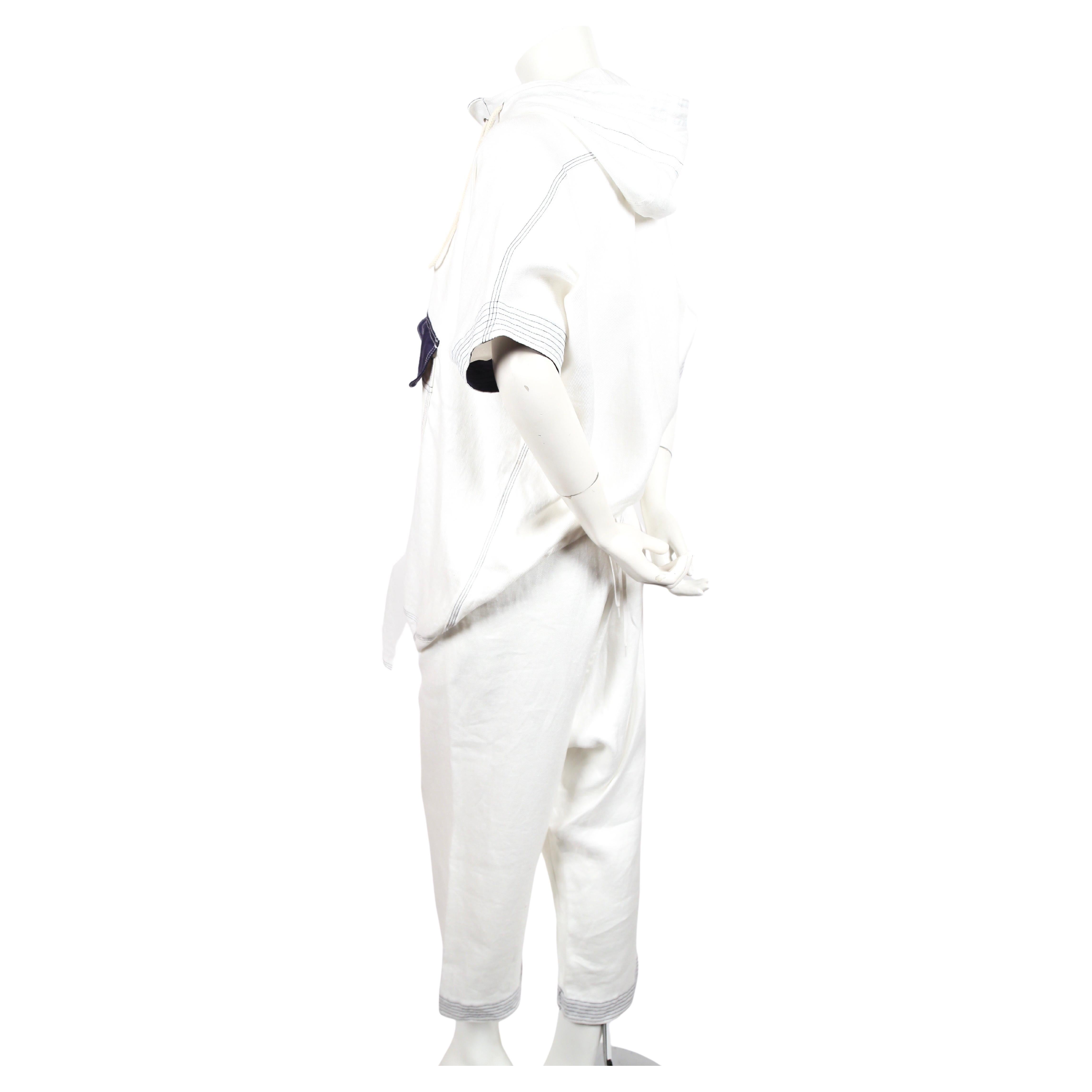 White cotton sailor suit with navy trim designed by Junya Watanabe for Comme Des Garcons as seen on the Spring 2011 runway. Size XS. Best fits a US size 2 or 4. For reference mannequin measures 34