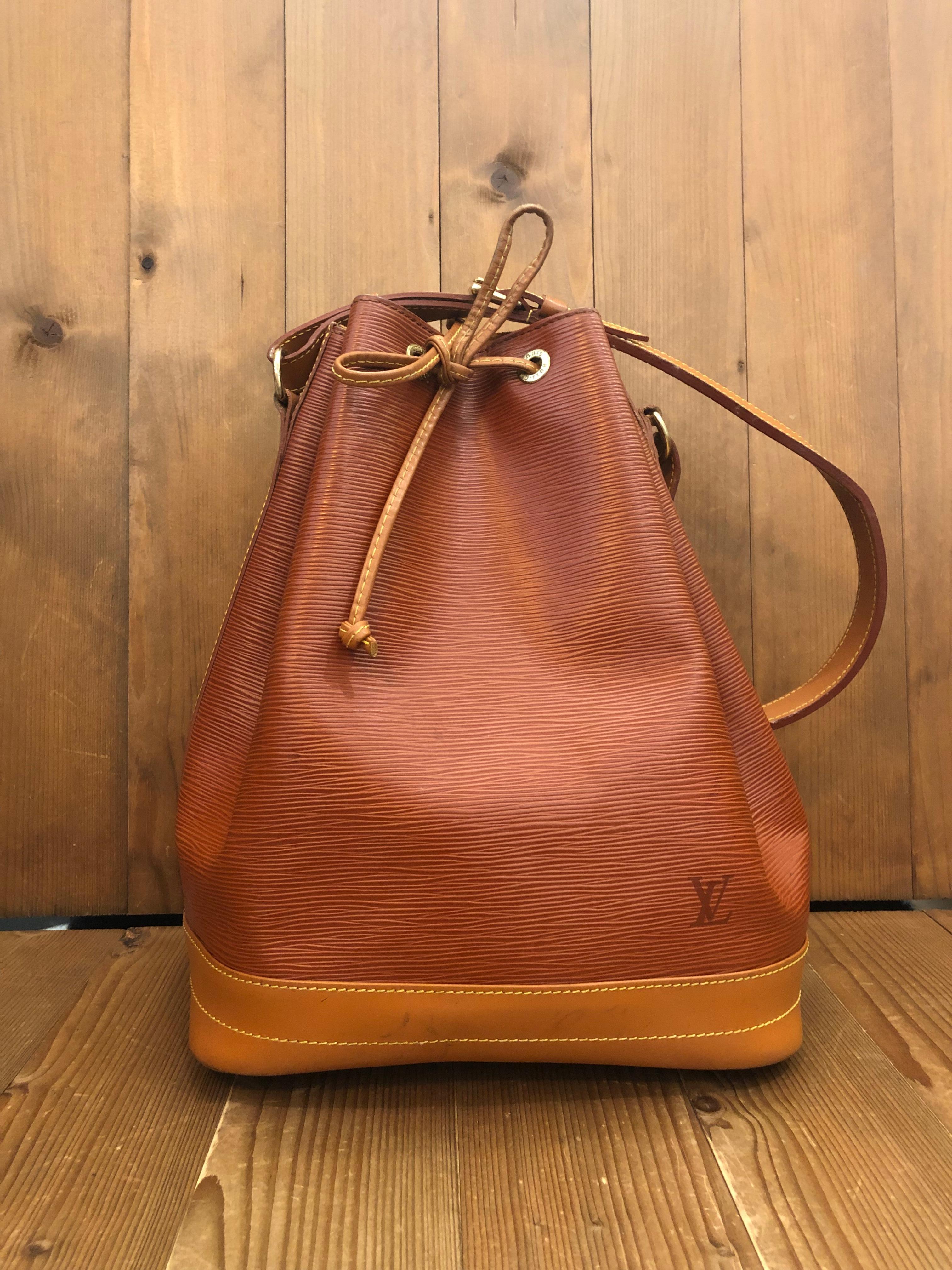 Vintage LOUIS VUITTON Noe GM shoulder bag in brown treated leather and Epi leather. This Noe is crafted of LOUIS VUITTON signature textured Epi leather in brown. It was originally created in 1932 to carry bottles of Champagne.Made in France in 1995