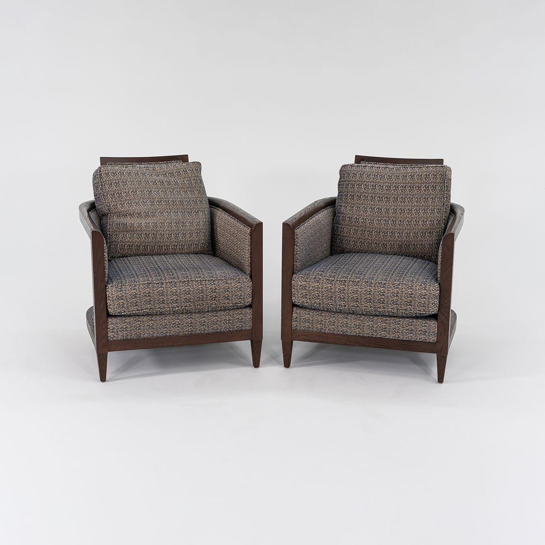 This is a pair of Hemp Sail Club Chairs, designed by John Hutton for Holly Hunt. The listed price includes the pair of two chairs as shown. Their design features an exposed frame of brown stained oak, and these examples have thick tweed fabric