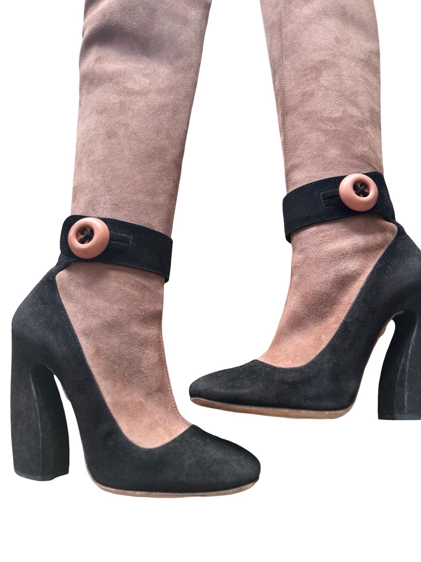 These incredible suede boots from the F/W 2011 Prada runway collection in a milk chocolate brown leather and contrasting black colorblock suede, architectural shaped heel and ankle strap with a big button.  The knee high is a sock boot style that