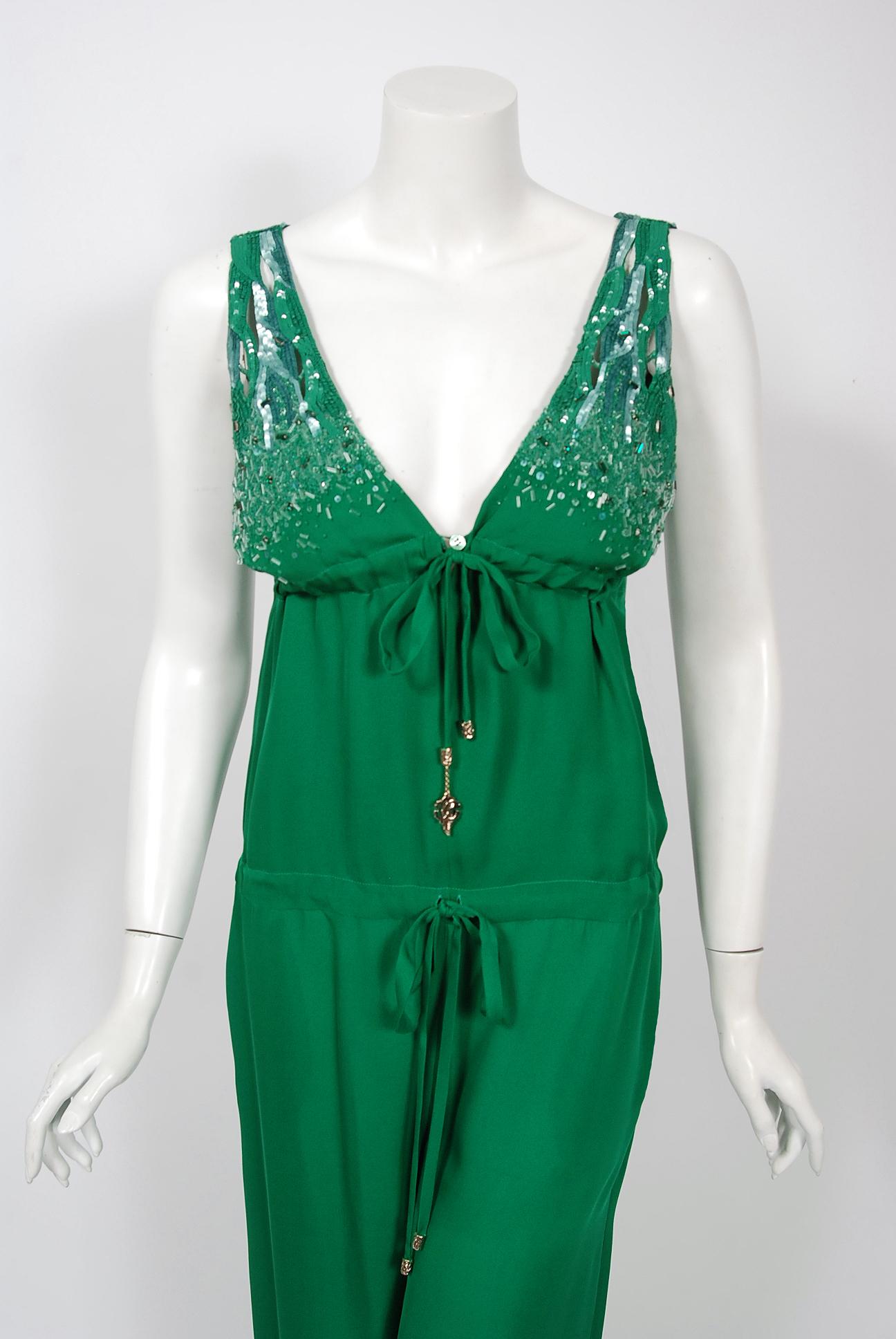 This gorgeous 2011 creation from Roberto Cavalli is not only striking but shockingly timeless. The fabric is luxurious emerald green high-quality silk upon which glass-beads and jewels in the matching hue have been worked in so there is a beautiful