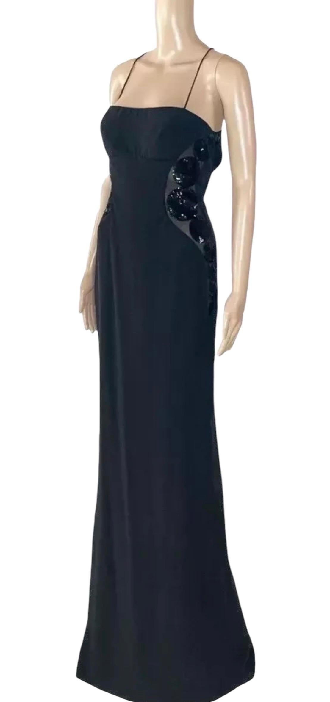 VERSACE 
Circa 2011
Incredibly elegant and sexy black silk gown.
Crossed straps on the back, sheer chiffon with embropidered pallete details.
Content: 100% silk, Lining: 100% silk.
IT  Size 38 - US 2
Armpit to armpit: up to 18