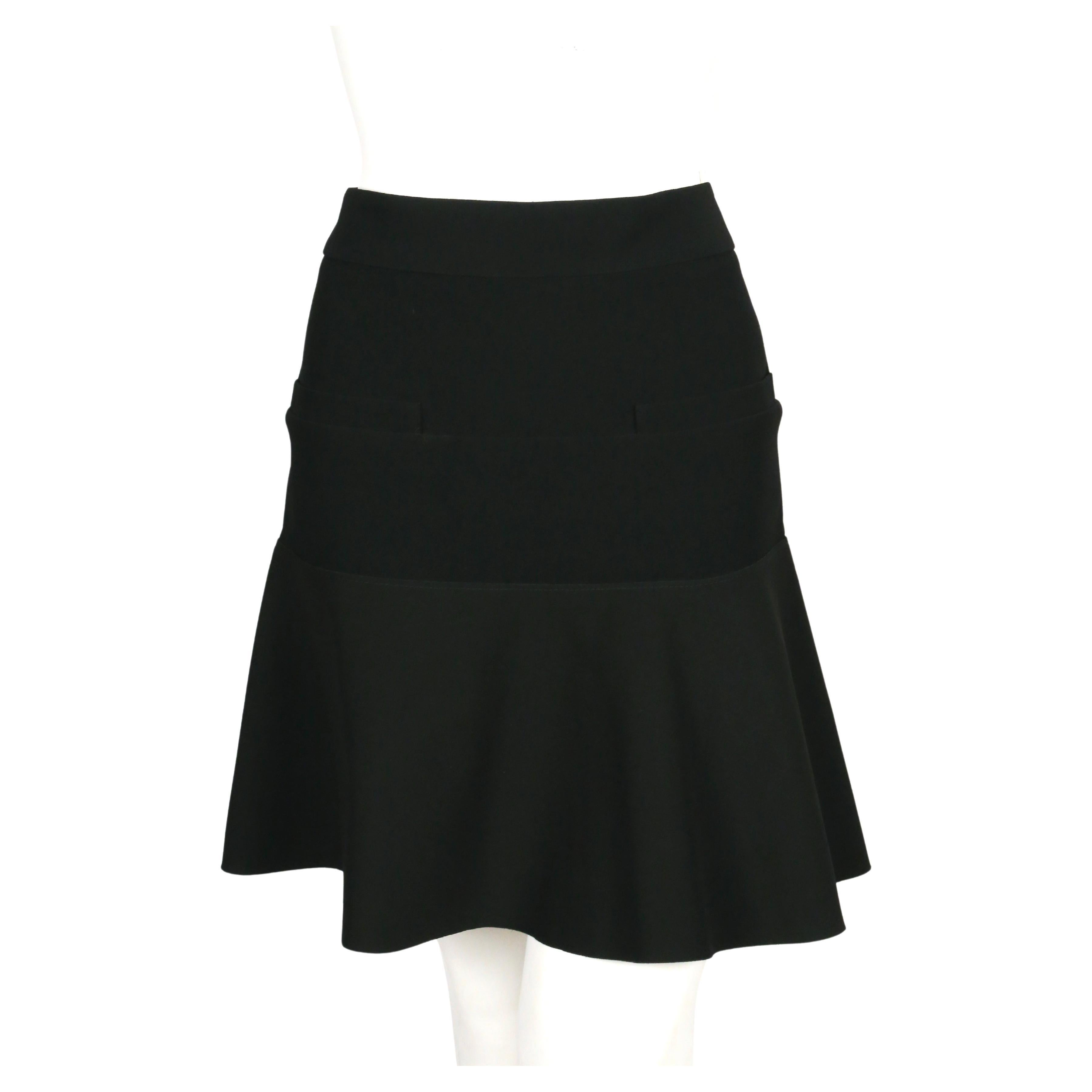 Black trumpet hem skirt designed by Phoebe Philo for Celine exactly as seen on the runway for spring of 2012, look #1. Very flattering and comfortable fit. Skirt is cleverly constructed of two different fabrics. Hem has a stiff fused fabric for a