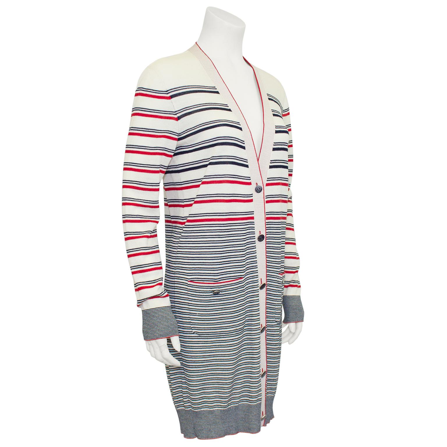 2012 Chanel striped knit cardigan. Cream with black and red horizontal stripes throughout. A great seasonal layering piece, as it is light weight enough to wear on a summer evening or layered over a black turtleneck in the winter. V neckline with