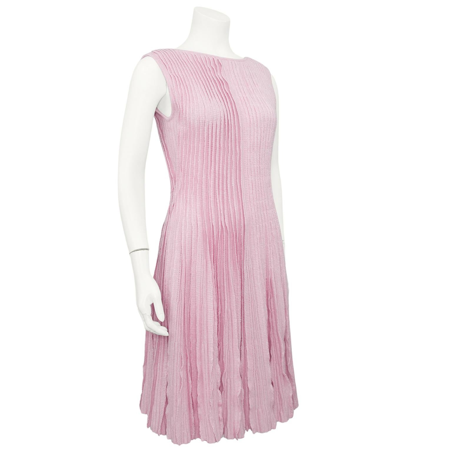 Delicate and stunning Chanel dress from 2012 in the most beautiful shade of soft pink. Boat neckline in the front with a scoop in the back. Sleeveless and skater style that is fitted through the body and a full skirt with lots of movement. 50%