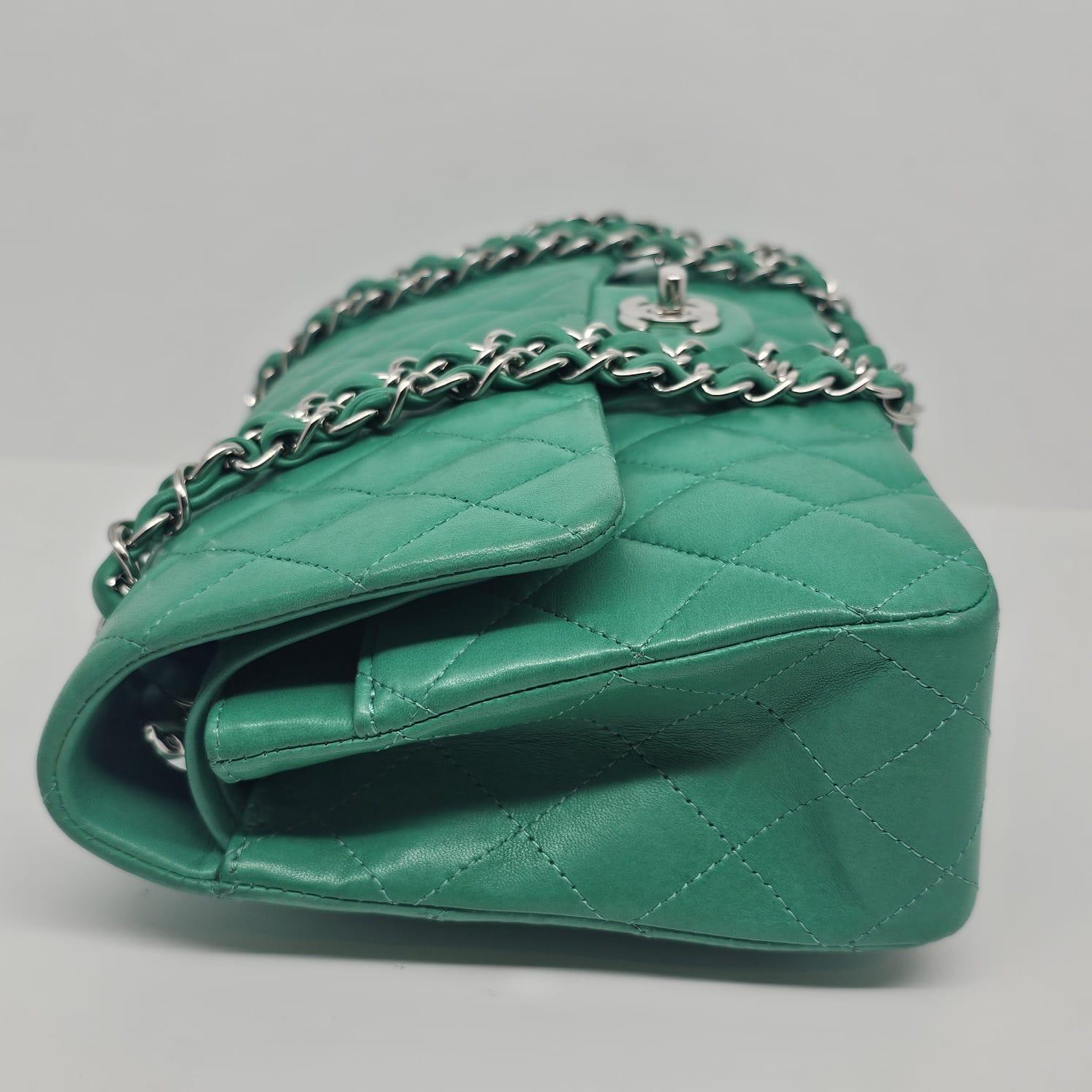 Classic Chanel medium double flap bag in turquoise lambskin leather with silver hardware. Slight use to the bag, with visible scratches and rubbing on the corners. Slight creasing visible on the bottom of the bag. Series #16. Comes with its holo