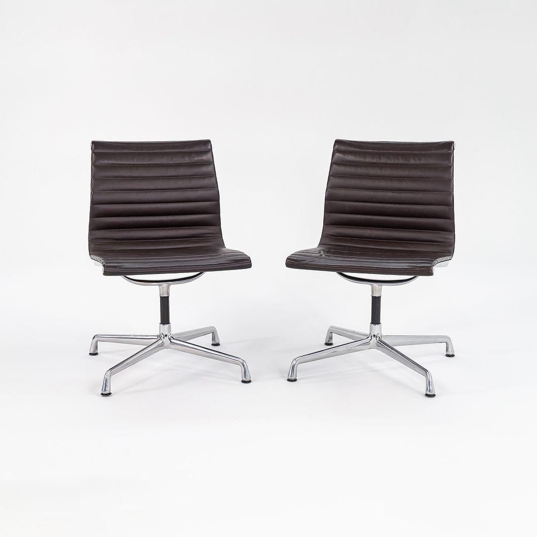 These are Eames Aluminum Group armless desk or side chairs, Model EA306S, initially designed by Charles & Ray Eames for Herman Miller in 1958. These examples were manufactured in 2012. The listed price includes one chair, and we have two available