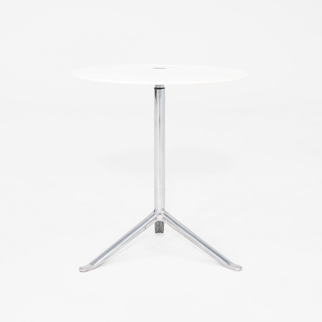 This is a Little Friend Side Table, originally designed by Kasper Salto in 2005. This example was produced by Fritz Hansen in Denmark in 2012. The table features a slim circular laminate top mounted on a height-adjustable stem with a three-point