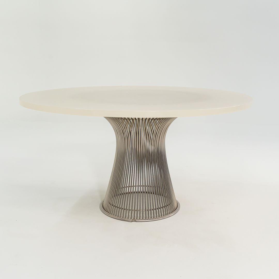 This is a Platner dining table, model 3716T, initially designed by Warren Platner for Knoll in 1966. This example dates to 2012. Its design features a base constructed with vertical steel rods that are welded to circular horizontal and edge-framing