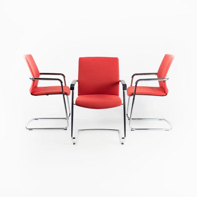 This is a single ON Cantiliever stackable side chair, designed by the Germany design group Wiege and produced by Wilkhahn. The chairs are beautifully constructed from chromed tubular steel and upholstered in a modern solid red fabric. Wilkhahn is a