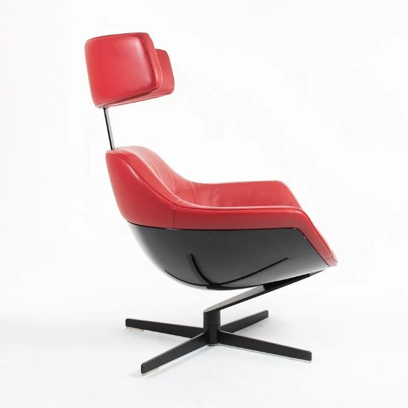This is an Auckland Lounge chair, designed by Jean Marie Massaud for Cassina in 2005. The piece was manufactured in Italy in 2013. It features soft thick red leather, and has a four-star base in matte black coated-steel. It has a full swivel