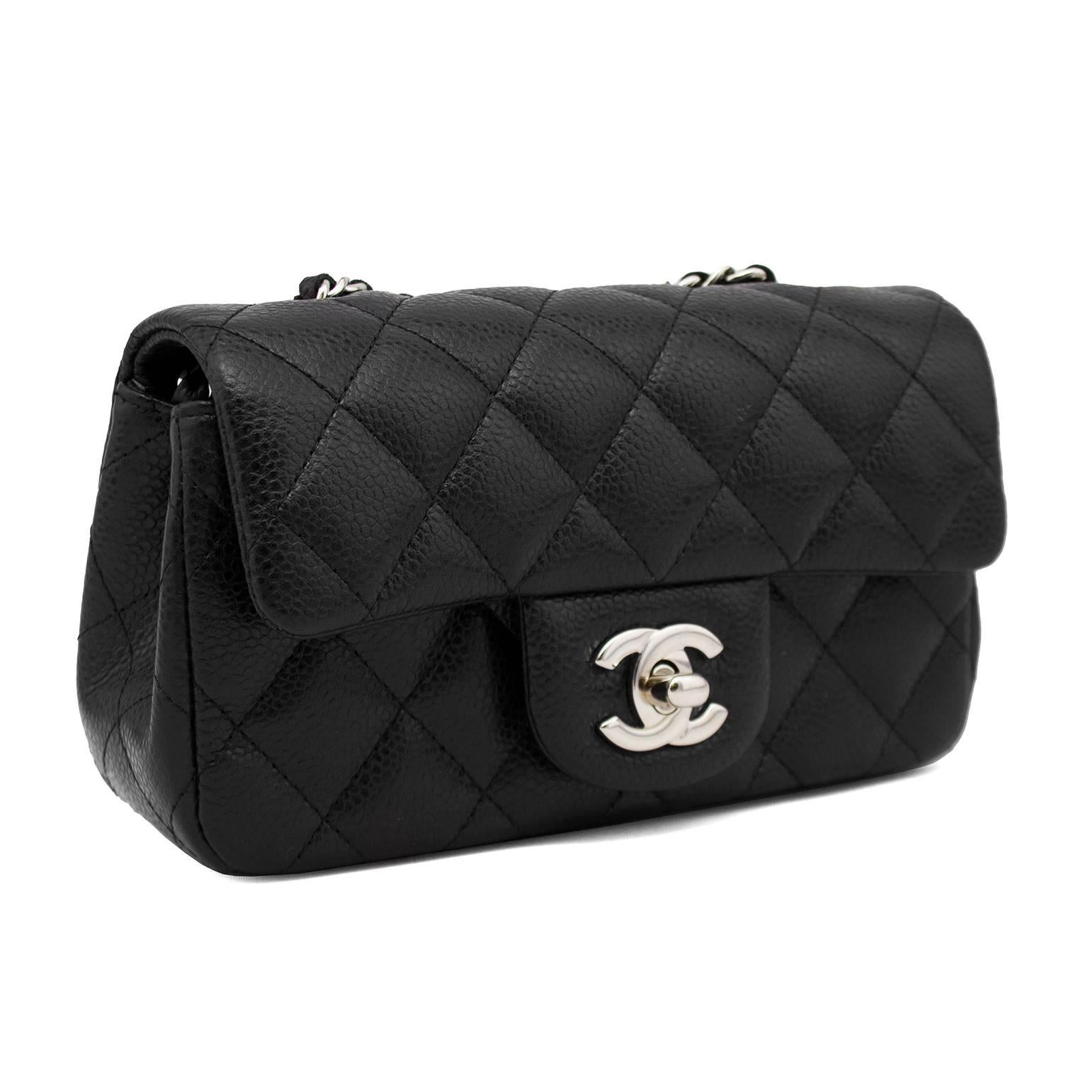 2013 Black quilted Caviar leather Chanel Classic Mini Flap Bag with silver hardware, single shoulder strap with chain-link and leather accents, dual interior compartments with single slit interior pocket.  Flap with CC logo turn-lock closure at