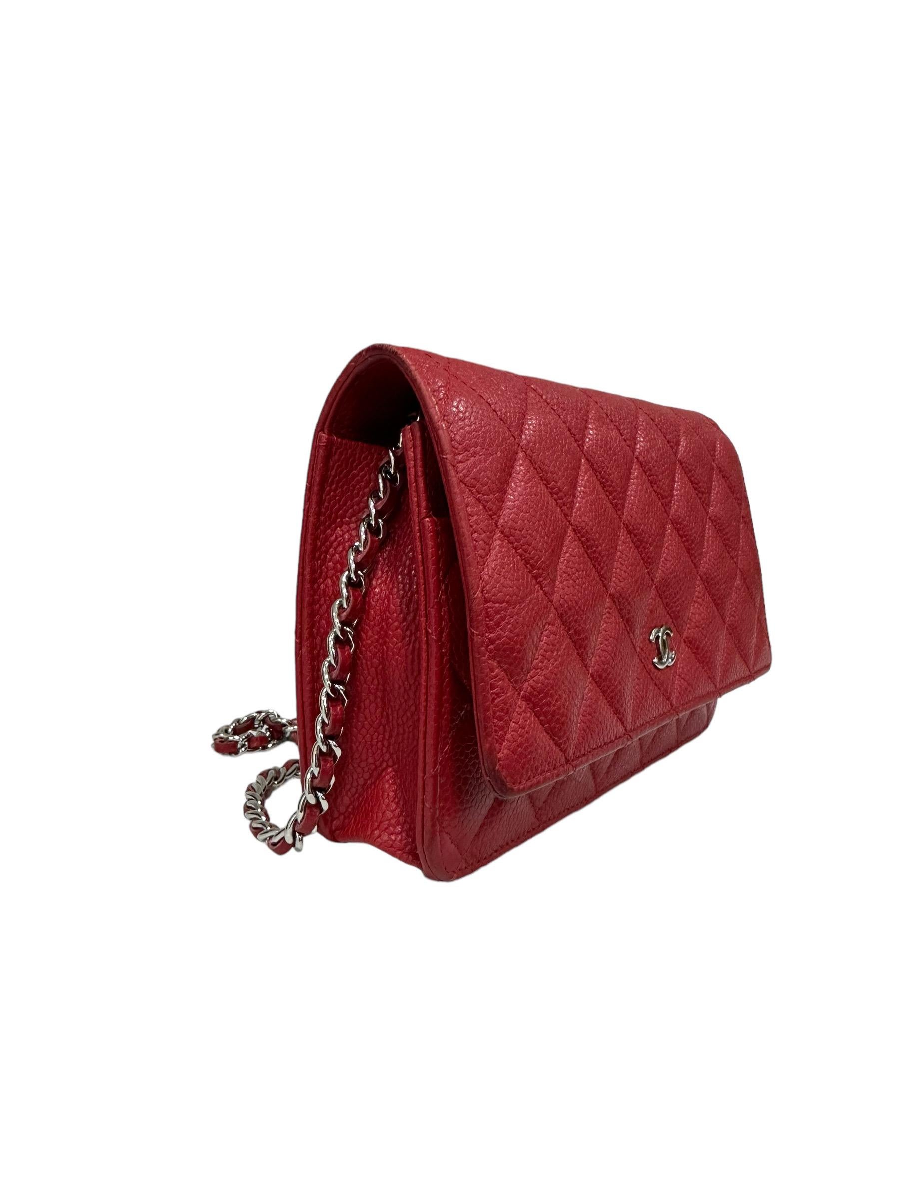 Chanel signed bag, Woc model, made in red caviar leather with silver hardware. Equipped with a flap with button closure, internally lined in red smooth leather, roomy for the essentials. Equipped with a leather and braided chain shoulder strap, and