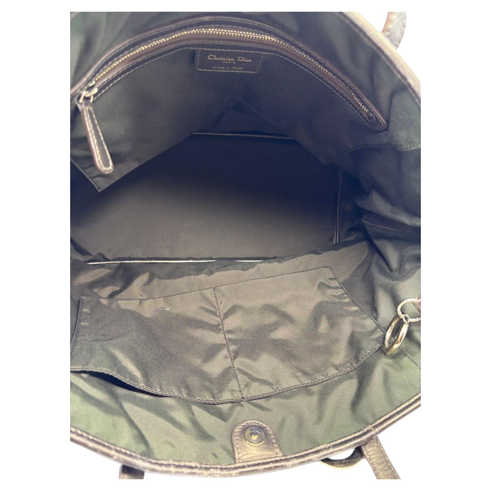 Dior panarea tote in black canvas with bronze leather trims. In used good condition. Heavy rubbing and scratching on the leather handles and trim. Lining is still clean. Overall in good condition. Slight tarnishing on the logo charm. Comes as is.