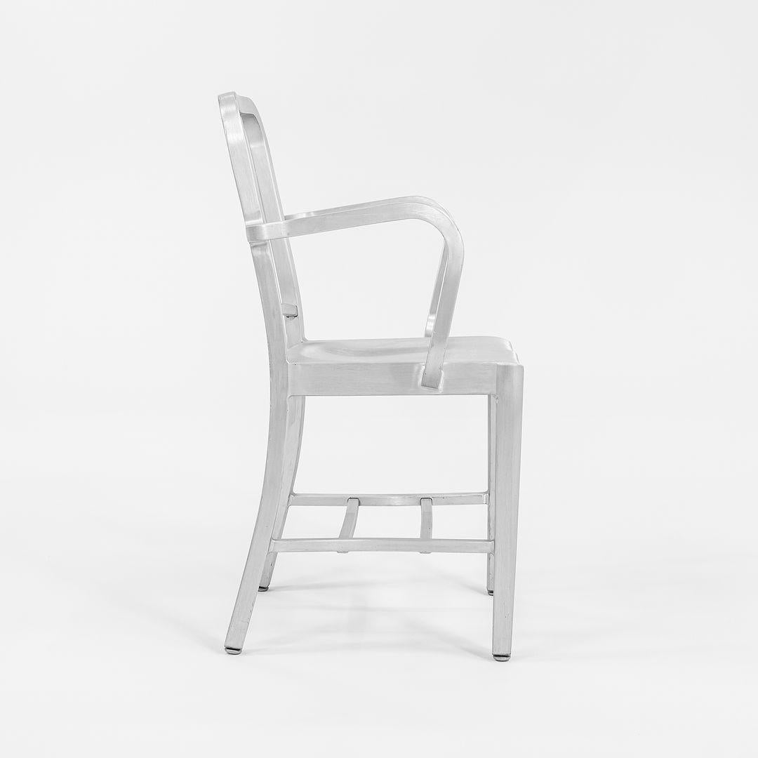 This is an original Emeco Armchair, Model 1006-A, designed in 1944 for the U.S. Navy. This example dates to 2013. The chair was built by hand from recycled aluminum in Hanover, Pennsylvania. Aluminum is an excellent material for seating as it is