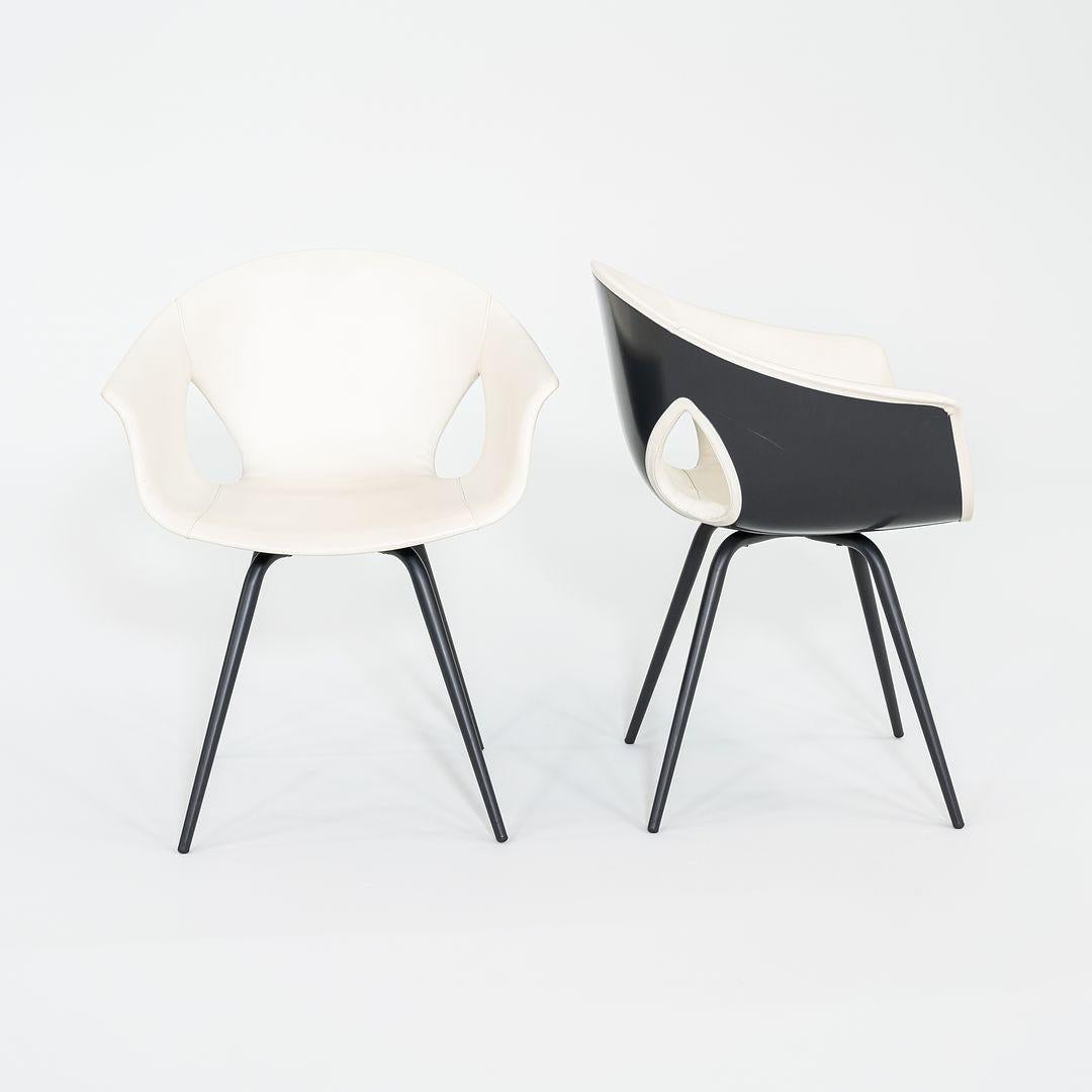 These are Ginger Ale dining chairs, initially designed by Roberto Lazzeroni for Poltrona Frau in 2012. The listed price includes one dining chair, and we have seven chairs available for purchase. Their design offers an outer shell made of molded