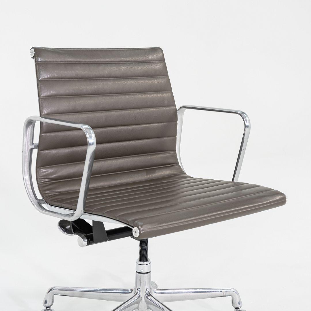 Si tratta di sedie da scrivania Eames Group Management in alluminio, modello EA335, originariamente progettate da Charles e Ray Eames per Herman Miller nel 1958. Questi esempi in particolare risalgono al 2013. Il design prevede una struttura in