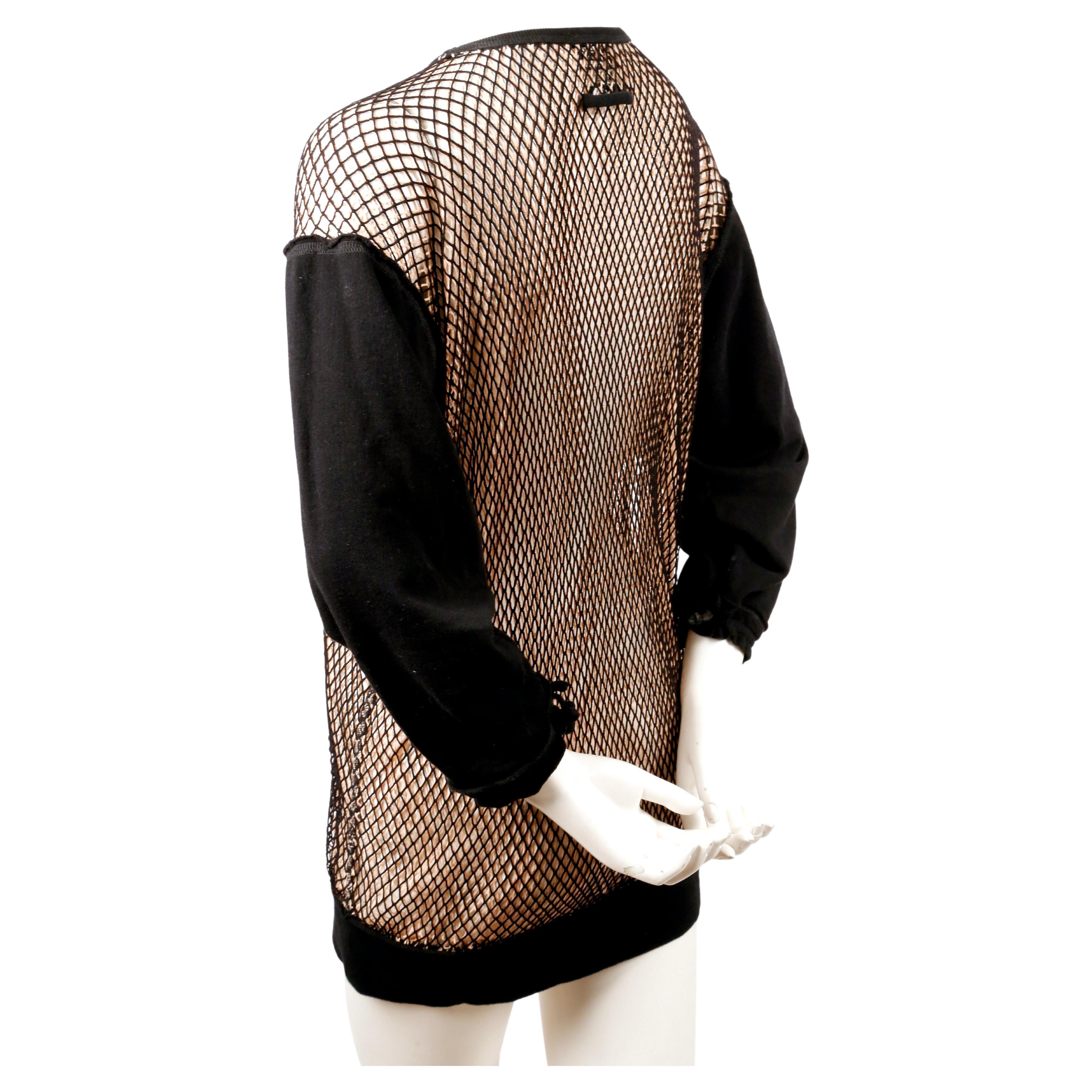Nude and black layered 'fishnet' tunic designed by Jean Paul Gaultier dating to spring of 2013 exactly as seen on the runway. Tunic is composed of two layers one black and the other nude, of fishnet.  Labeled a size 'M'.  Approximate measurements: