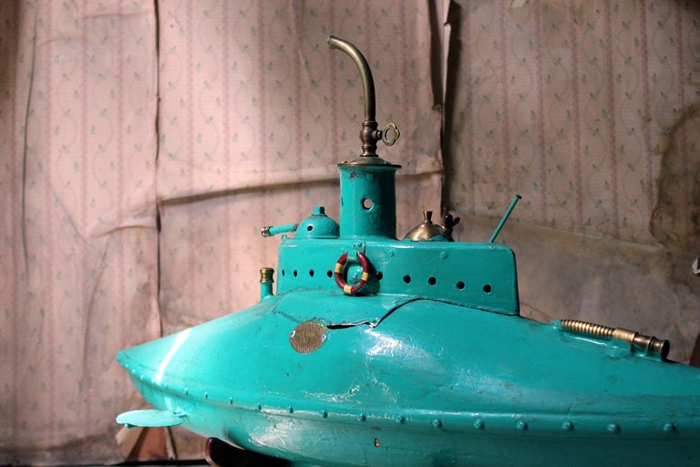 The large scratch-built submarine in turquoise paint, sitting on a turned wood customised stand, each with brass plaques reading ‘Petrusson Tom 2013 Ironworks’ and ‘Seahorse Experimental Petrol Submarine TP/.Eng.’ respectively, the submarine having