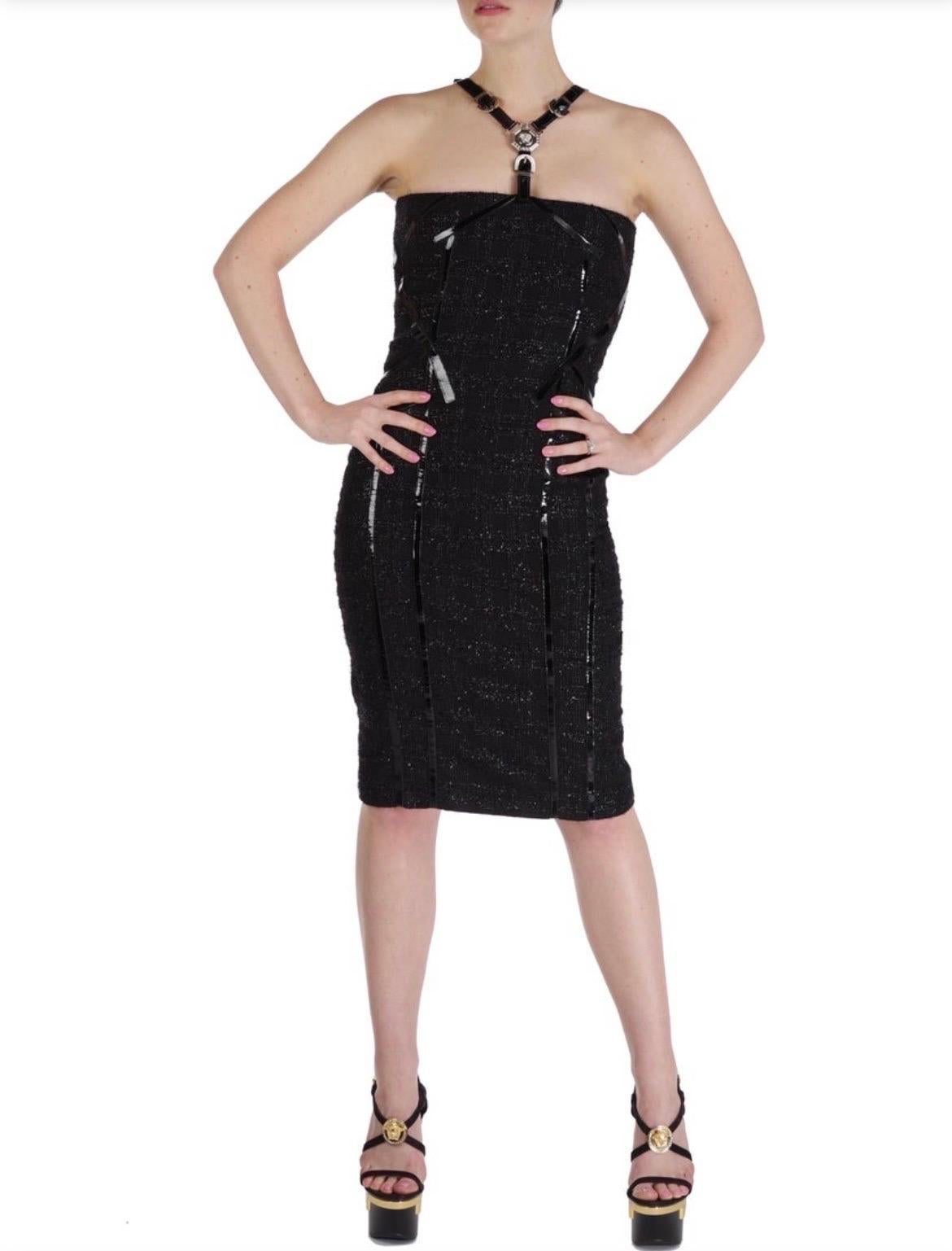Versace Black Embellished Midi Dress
Size  38 or US 2/4
Chic design ensure a stunning silhouette. 
Finished with metal hardware and Japanese vinyl.
Content: 49% nylon, 32% wool, 13% polyester, 6% viscose
Lining: 94% silk, 6% elastane.
Armpit to