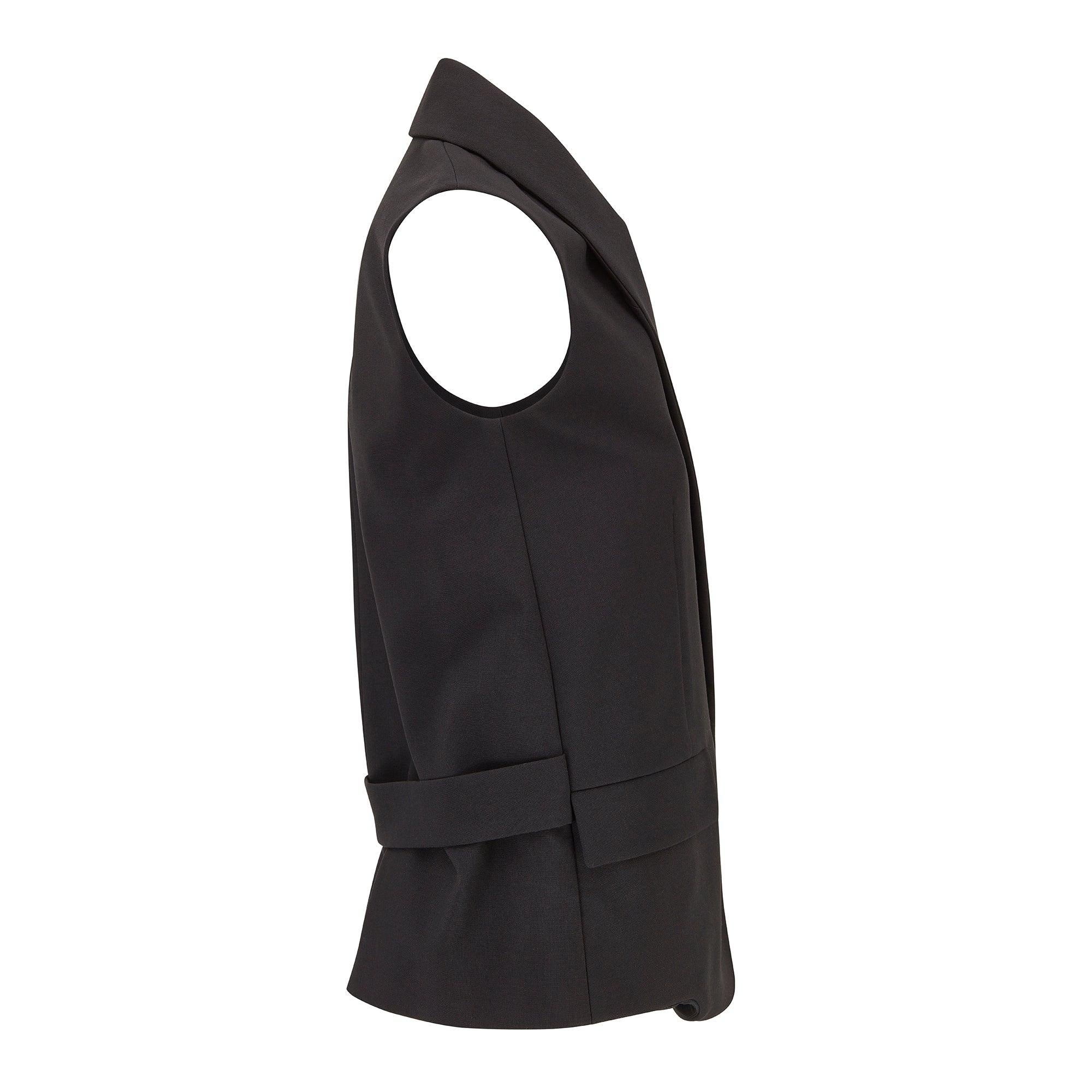 This chic black waistcoat was designed by Balenciaga in 2014 when Alexander Wang was Creative Director.  Wang brought an edgy aesthetic to the brand, infusing traditional elegance with a modern urban twist and his tenure saw the introduction of new