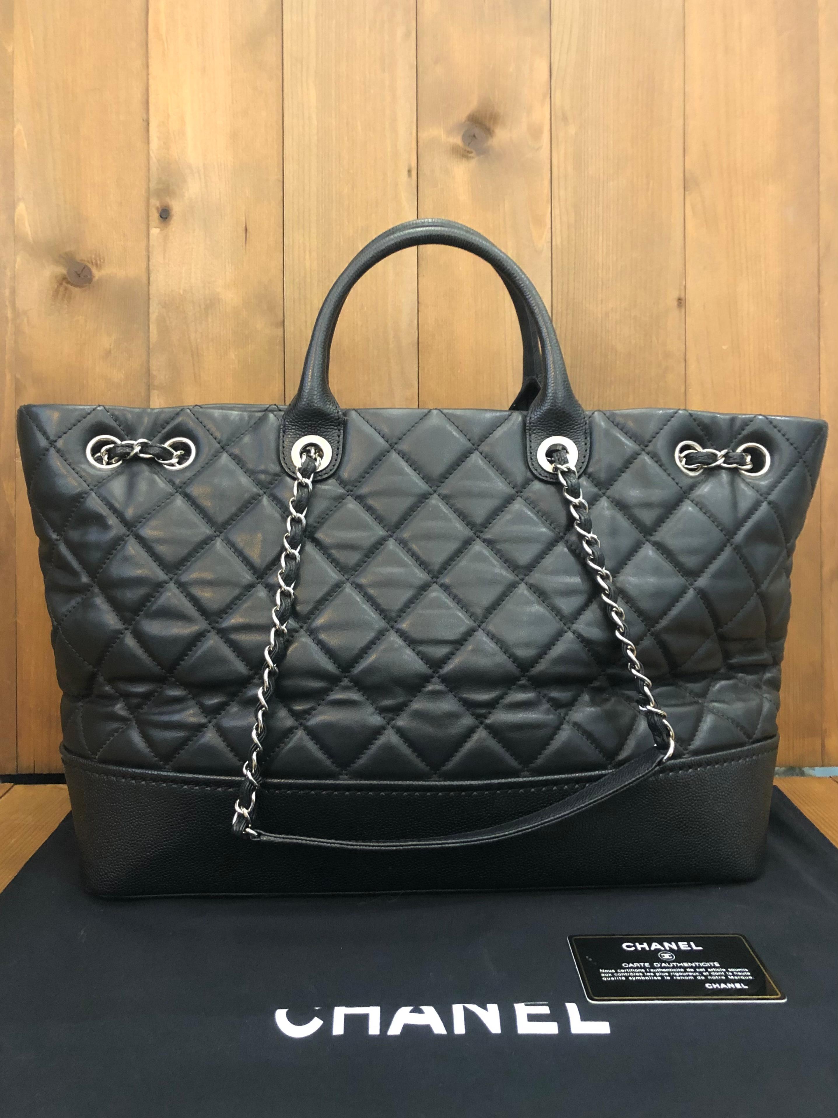 This CHANEL XL two-way chain tote is crafted of calfskin and caviar calfskin leather in black featuring sliver toned hardware. Wide top opens to a spacious compartment featuring patch and zippered pockets. This Chanel tote also features handles