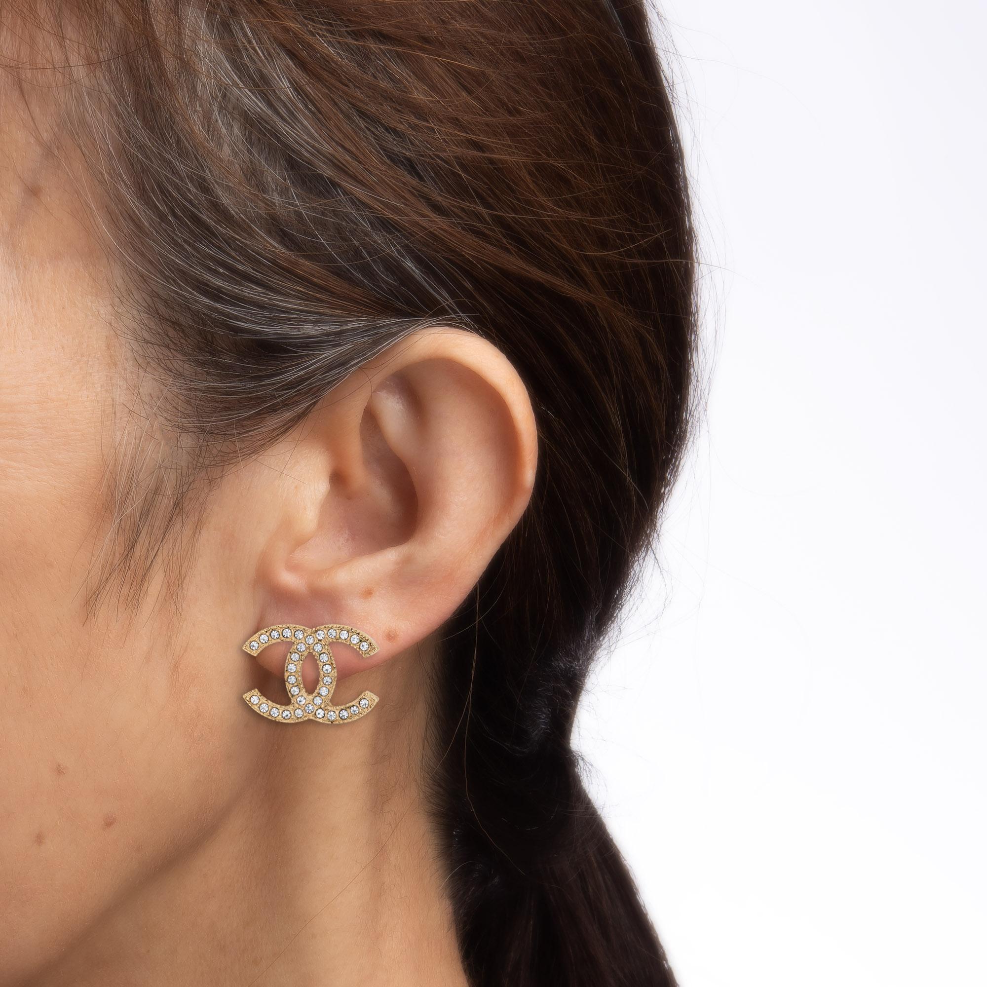 Estate Chanel CC logo crystal earrings (circa 2014) crafted in yellow gold tone.

Crystals are set into the 'CCs', with the crystals intact and in good condition. The earrings measure 0.47 x 0.62 inches and sit nicely on the earlobe. The earrings