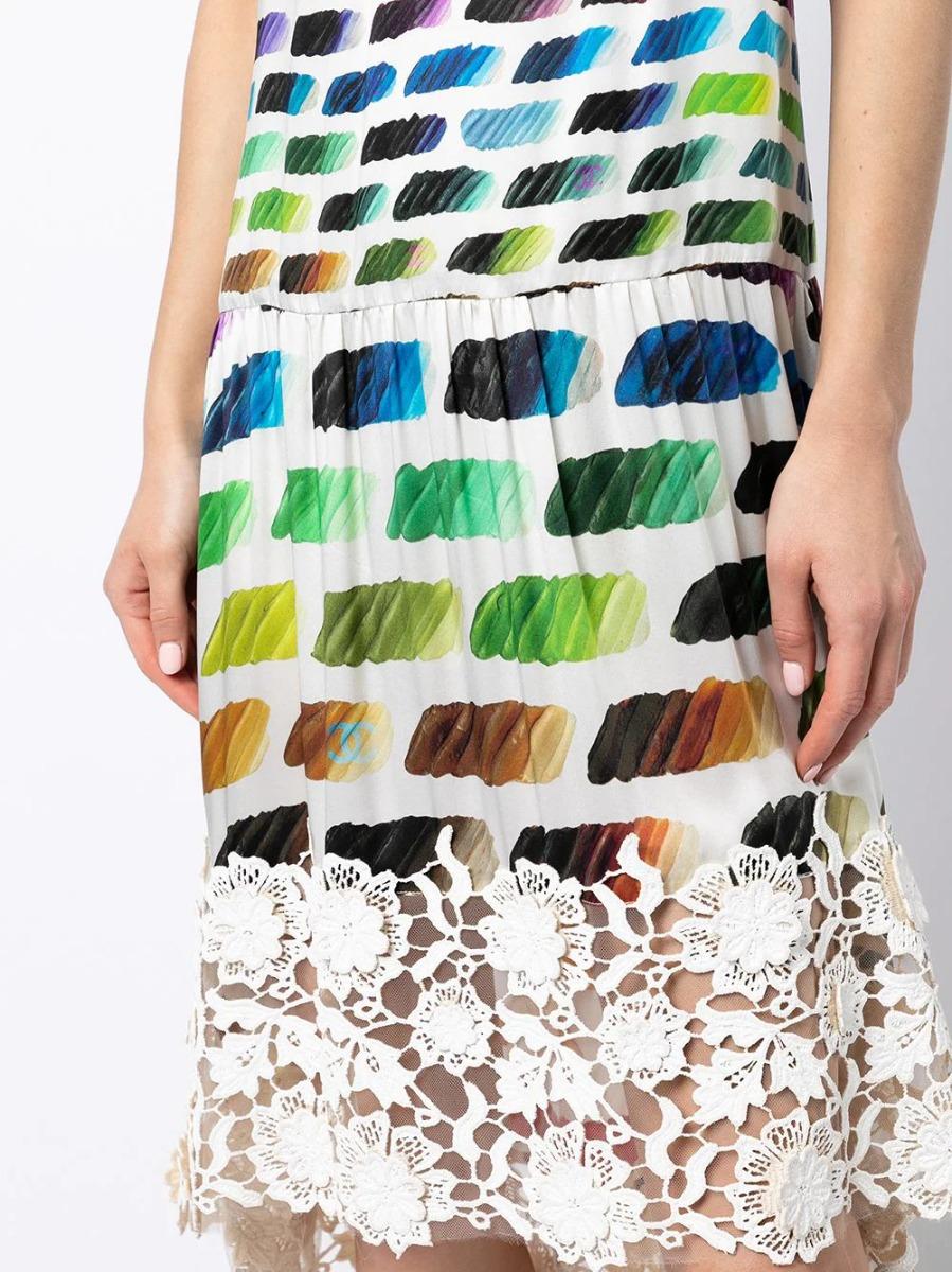 From Chanel's 2014 spring runway collection, designed by Karl Lagerfeld, this pre-owned Colorama silk dress features a rainbow colour swatch pattern, an elegant white floral lace panelling on the chest and hem and finished with thin white spaghetti
