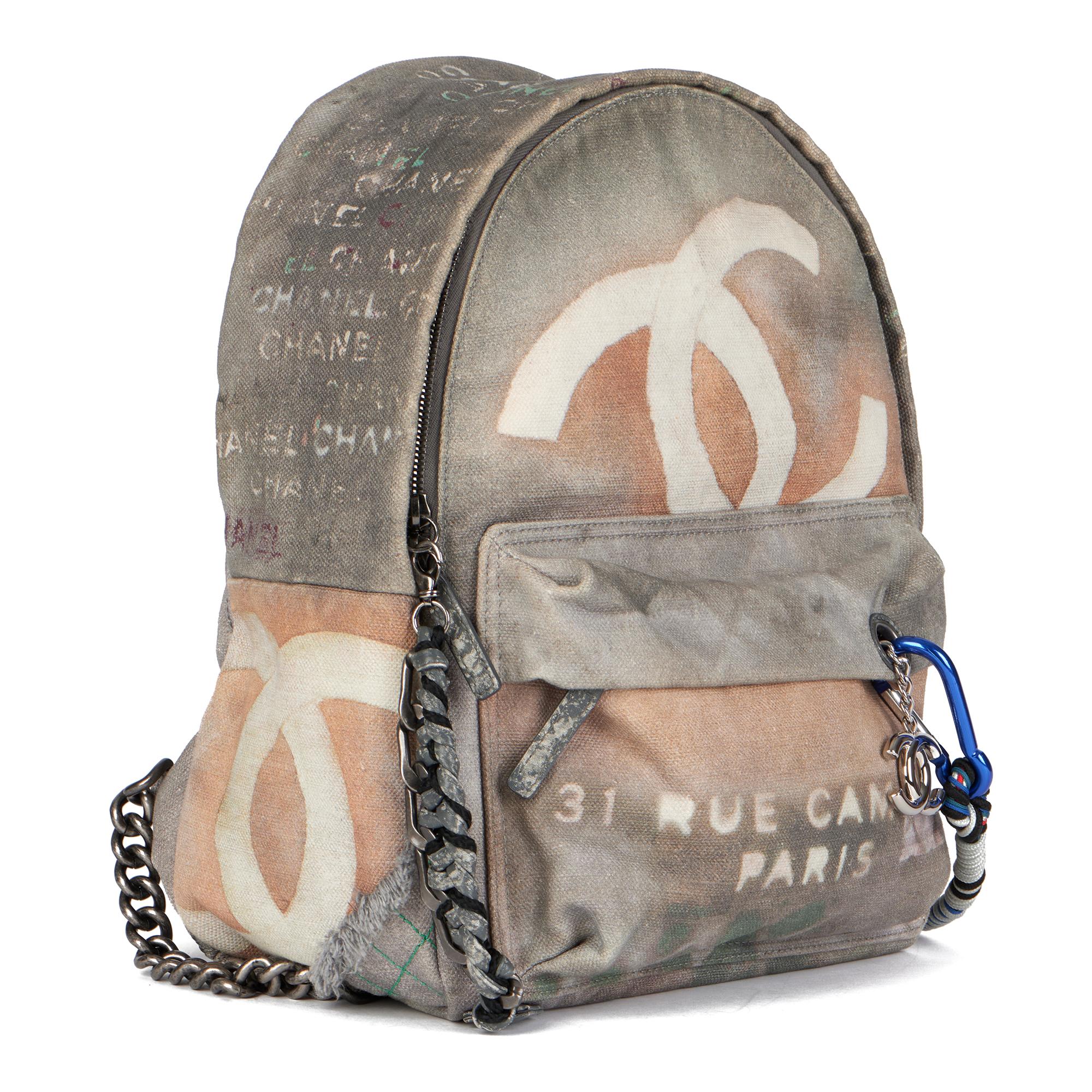 CHANEL
Grey Painted Canvas Medium Graffiti Backpack

Xupes Reference: HB3992
Serial Number: 19434766
Age (Circa): 2014
Accompanied By: Chanel Dust Bag, Box
Authenticity Details: Serial Sticker (Made in Italy) 
Gender: Unisex
Type: Backpack

Colour: