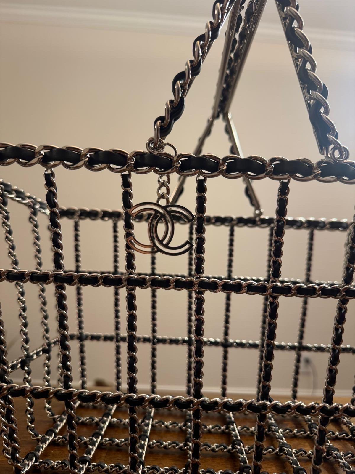 The Chanel Grocery Basket Bag, introduced in the Spring 2014 collection, is a distinctive piece designed to resemble a supermarket shopping basket. This collector’s item measures approximately 
20cm in height, 36cm in width, 27cm base, and 14.5 cm