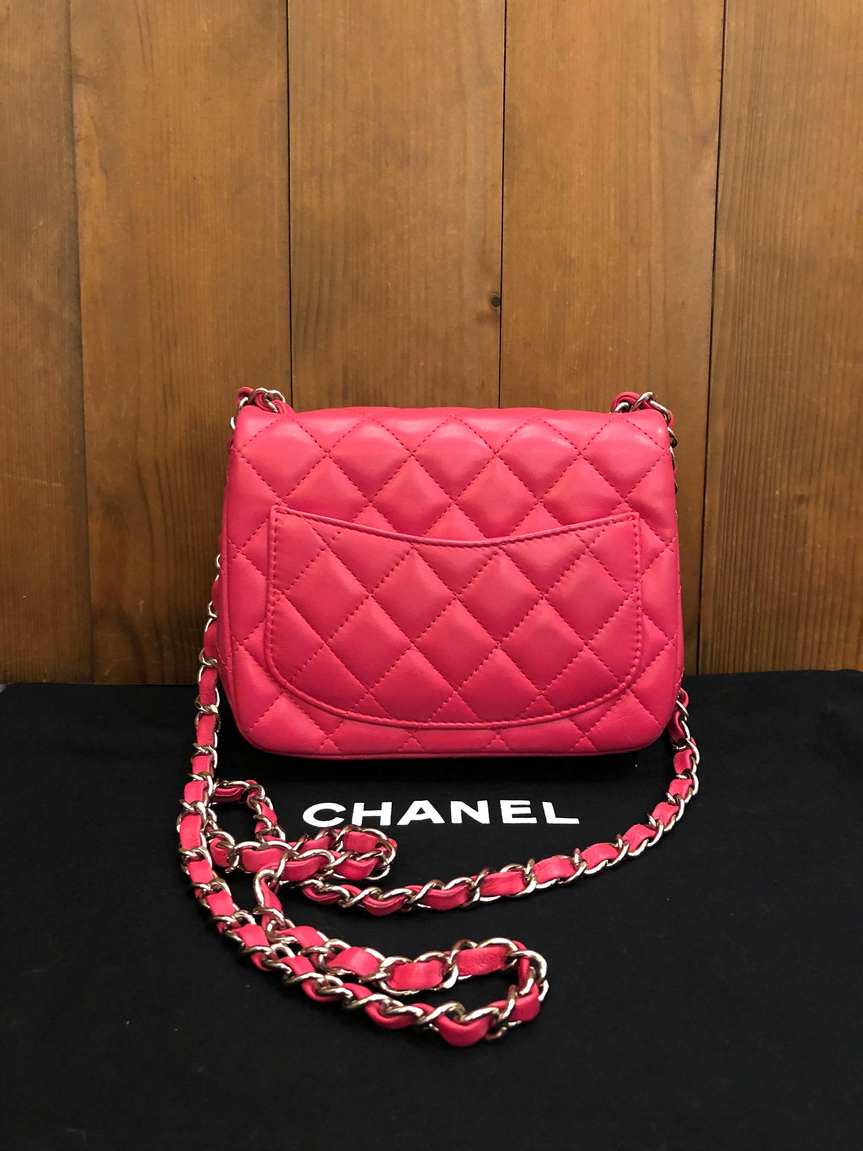 2014 Chanel mini flap bag in pink lambskin leather. It is compact in size and is the perfect bag that holds your cell phone, keys, and lip gloss. It also features an inside open flat pocket that fits cards or money as well as one zip pocket for