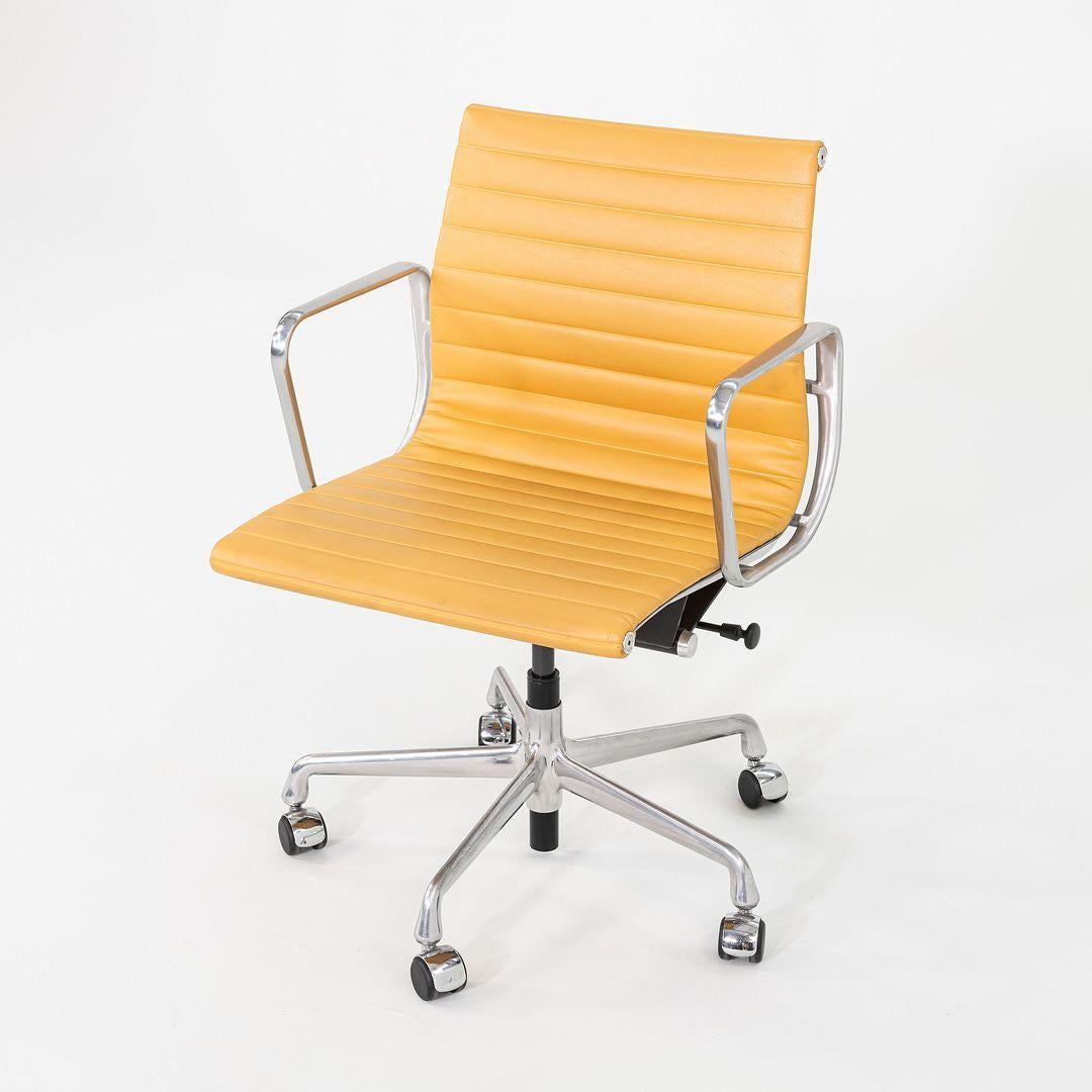 These are Eames Aluminum Group Management Desk Chairs, model EA335, originally designed by Charles and Ray Eames for Herman Miller in 1958. These particular examples date to 2014. Their design includes a solid yet lightweight aluminum frame, and