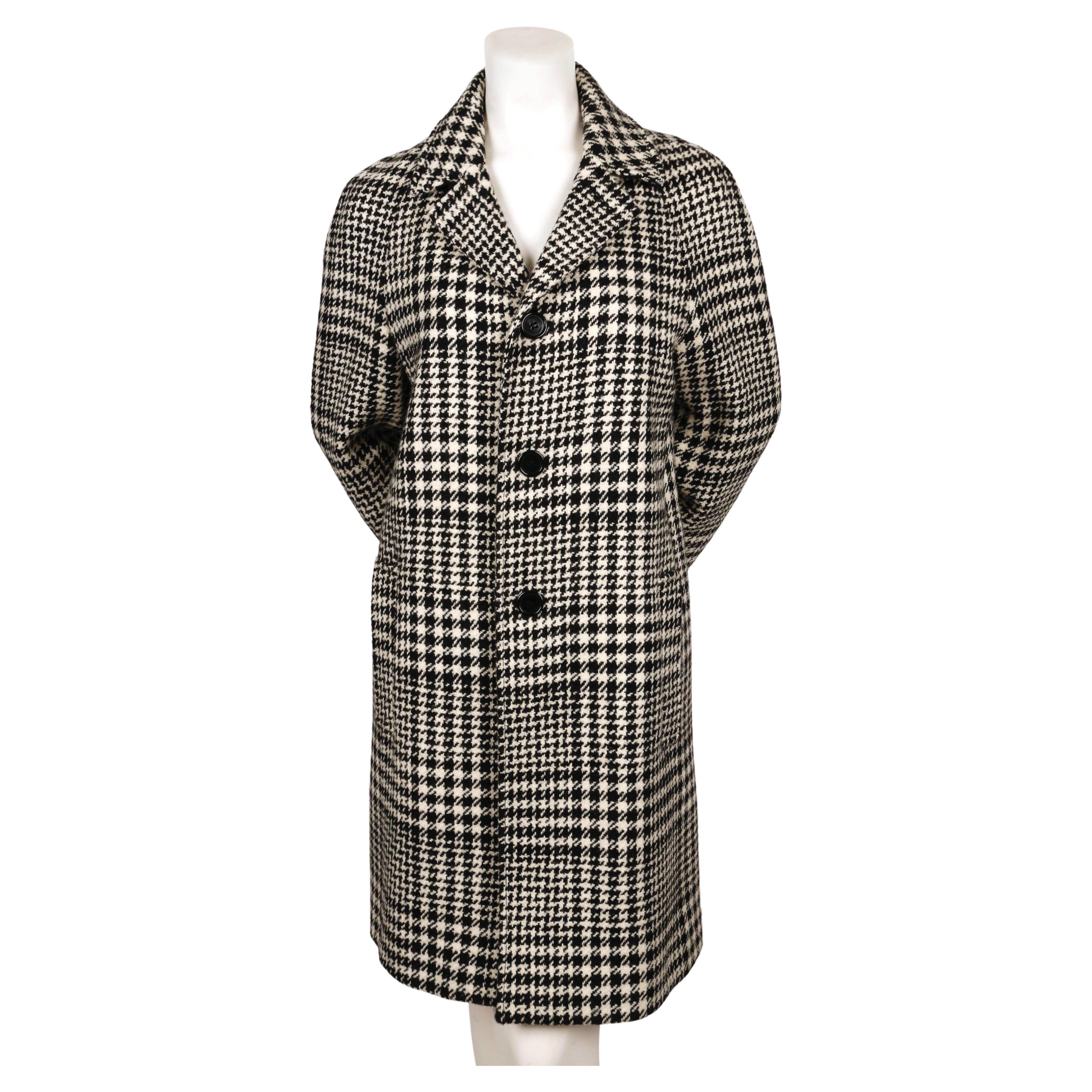 Black and off-white houndstooth woven wool overcoat by Saint Laurent dating to fall of 2014. Same coat seen on the runway . French size 40.  Approximate measurements: 40