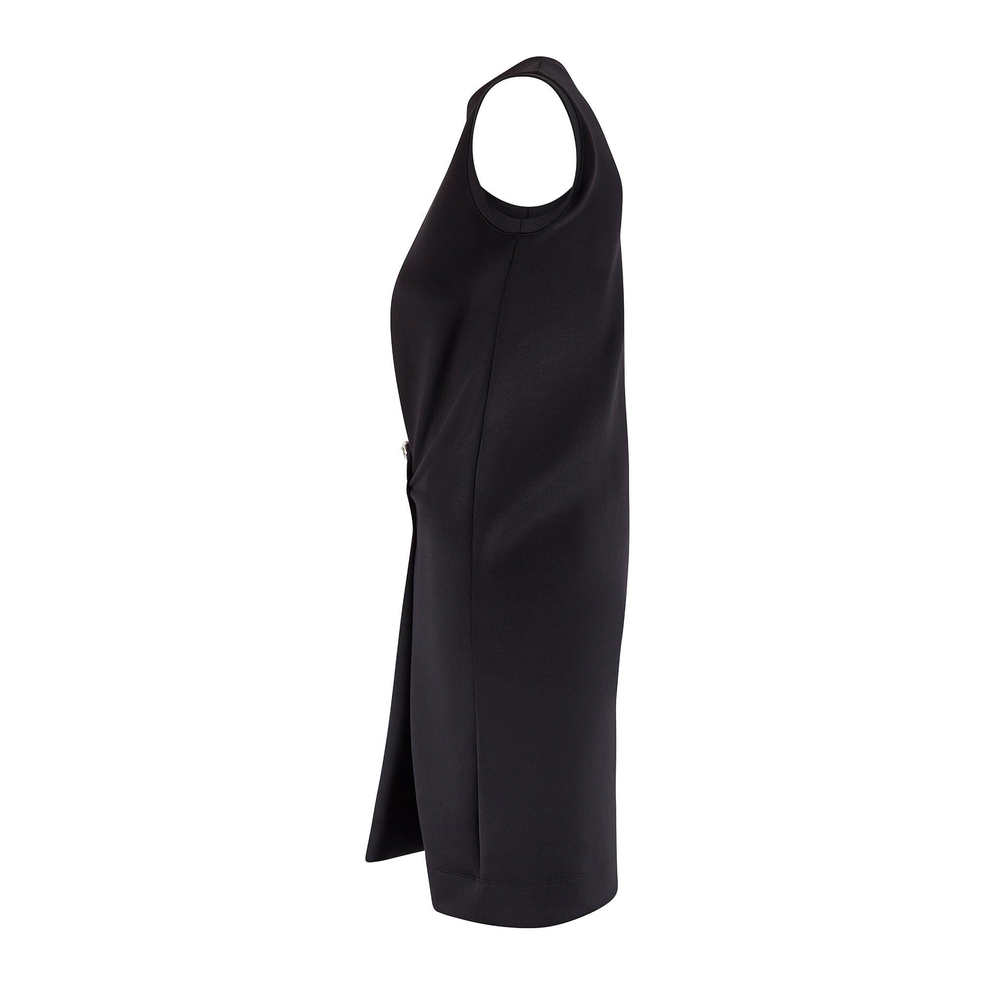This chic Balenciaga black dress is from the Fall 2015 collection and was designed by Alexander Wang. Tailored from smooth, bouncy neoprene, it is cut to a relaxed, sleeveless style with a rounded neckline. The silhouette is cocooning and draws on