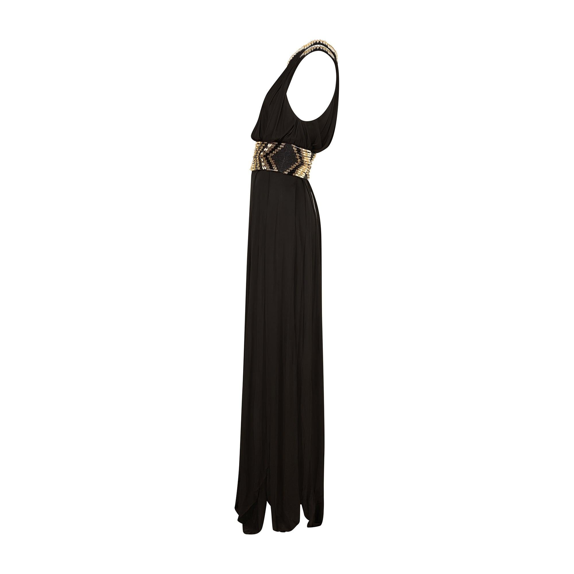 This weighty, embellished dress was designed by creative director Olivier Rousteing for Balmain's Resort 2015 collection. The Vogue review made reference to how the pieces were 