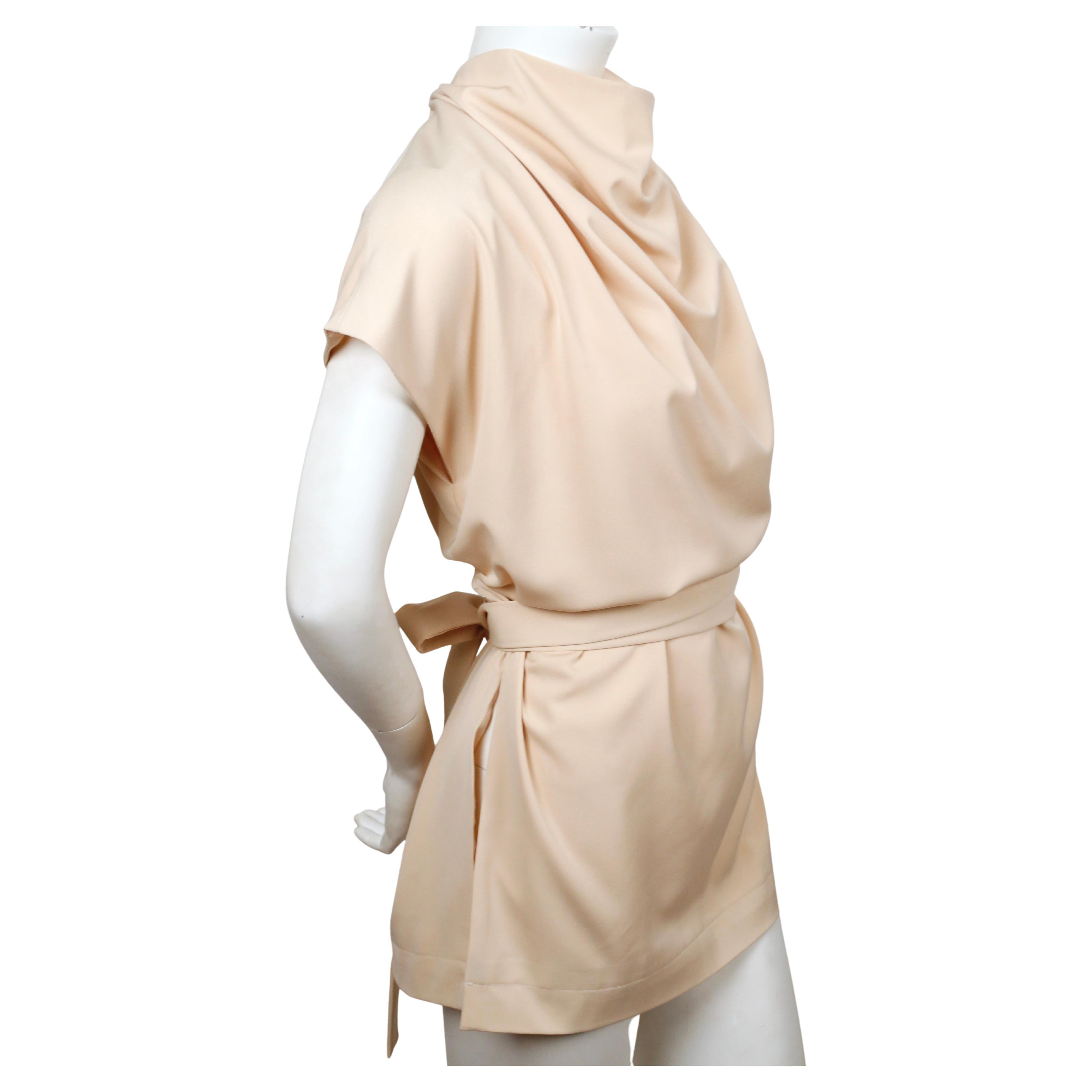 Draped, cream tunic with long ties designed by Phoebe Philo for Celine dating to 2015. No size label or fabric content label is present however this best fits a French 36-40. Approximate measurements: bust 45