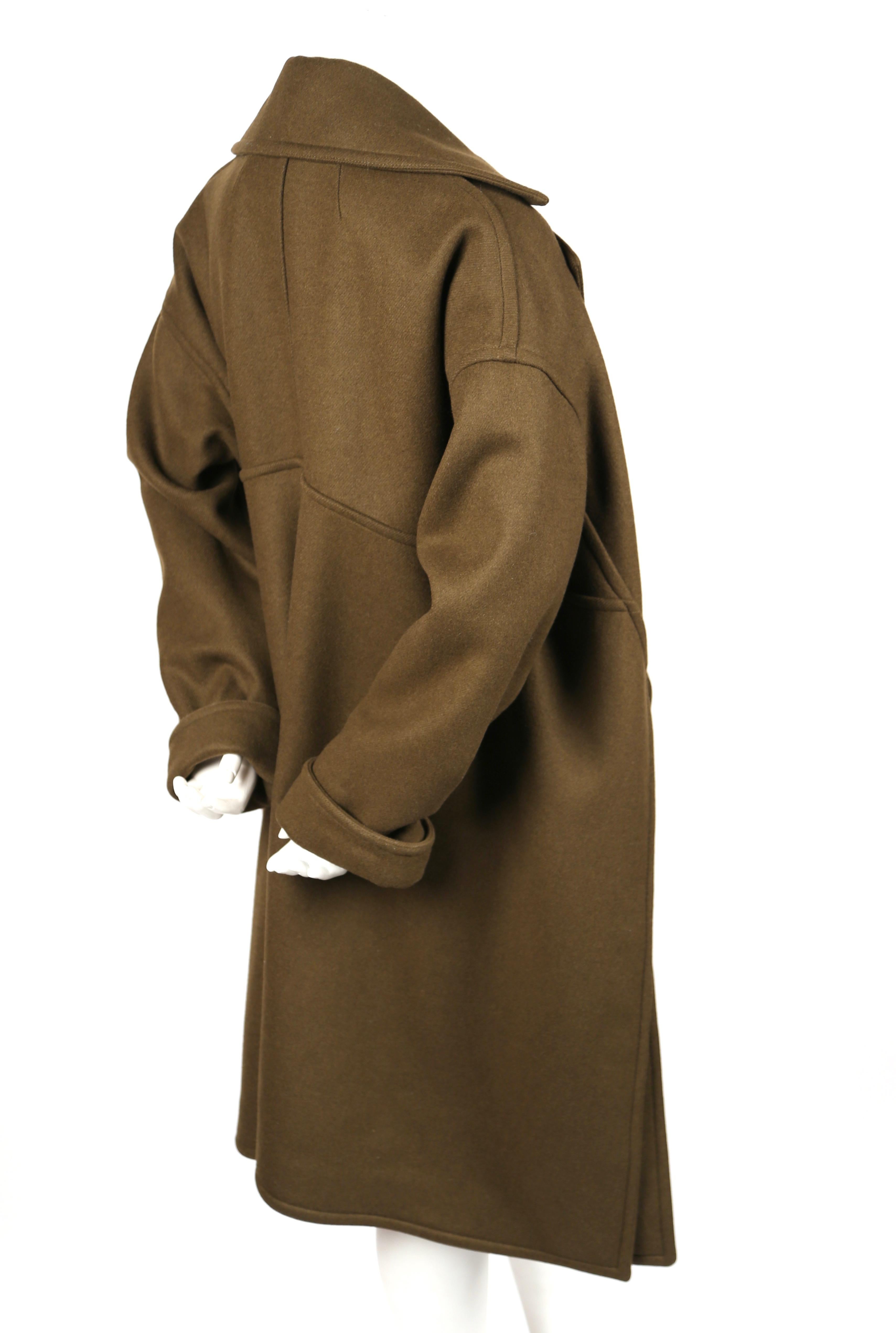 Stunning, khaki wool coat with open closure designed by Phoebe Philo for Celine dating to pre-fall of 2015, look 5. Labeled a French 36 however due to oversized cut, it will accommodate many sizes. Approximate measurements: bust 44