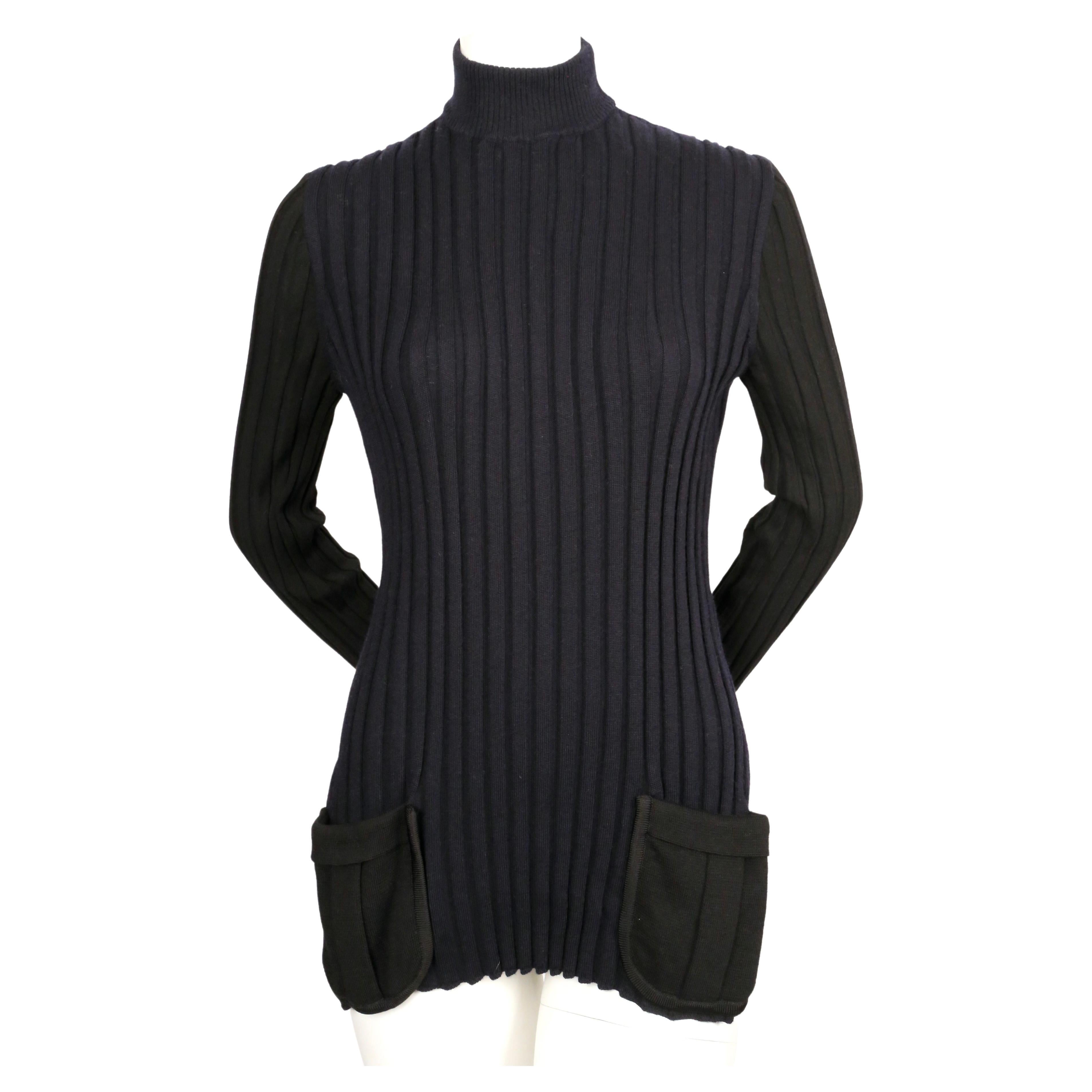 Navy blue and black tunic with slits and contrasting patch pockets designed by Phoebe Philo for Celine dating to fall of 2015. Similar sweater seen on the runway. French size M. Approximate measurements (unstretched):  shoulder 10