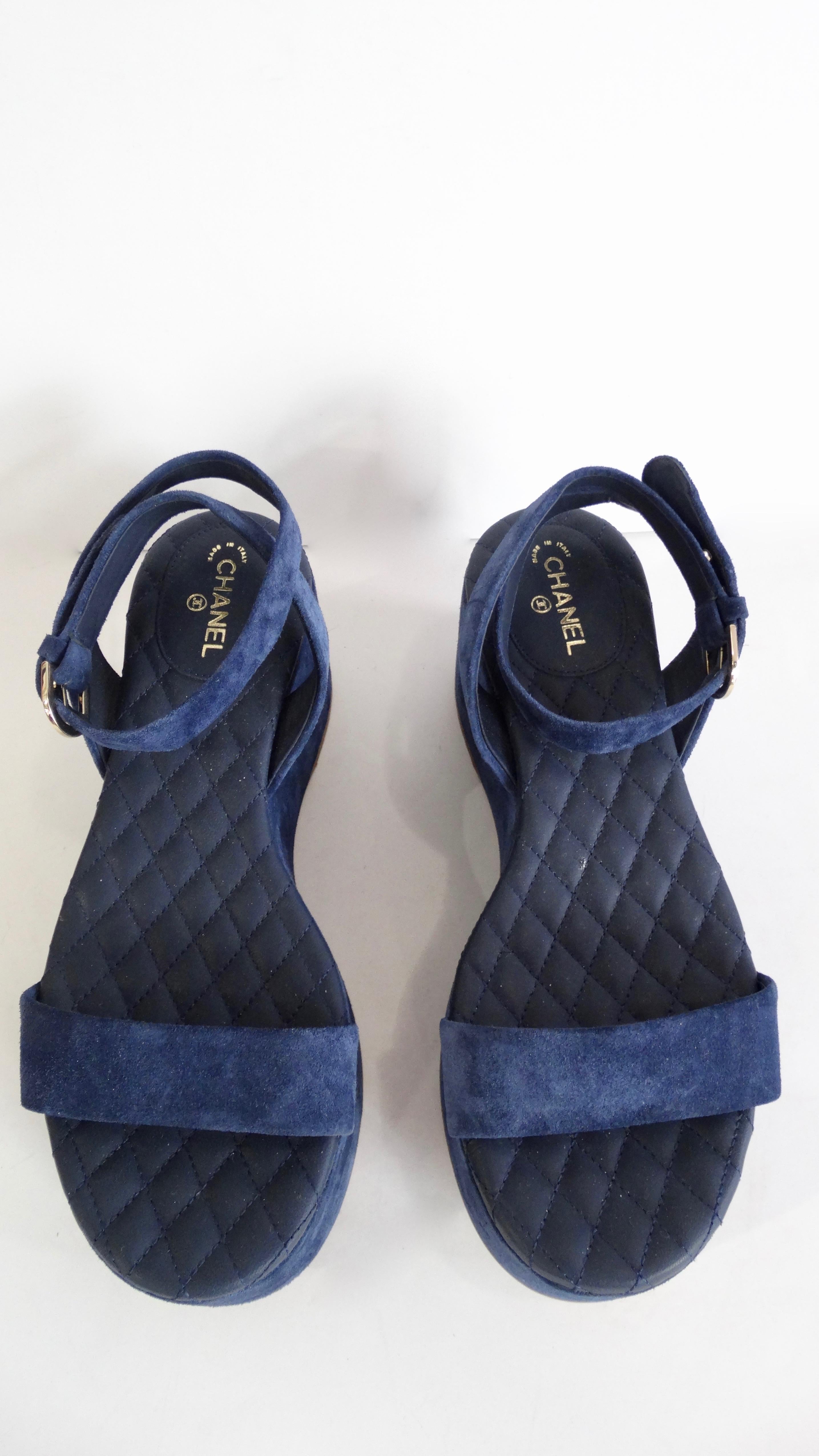 Take a walk with Chanel! Circa 2015, these platform sandals are made of blue suede and feature the signature Chanel quilting on the insole. Includes a CC logo at the heel and a wrap ankle strap with a 