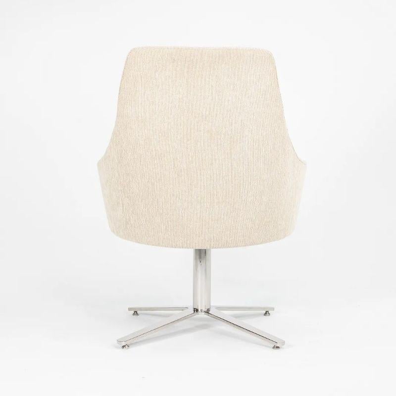 This is a Clover high-back swivel lounge chair, model 2672, produced by Cumberland in 2015 . This particular chair has a swivel x-base in polished stainless steel, and it has an upholstered seat and back which is done in a Maharam Steady fabric, in